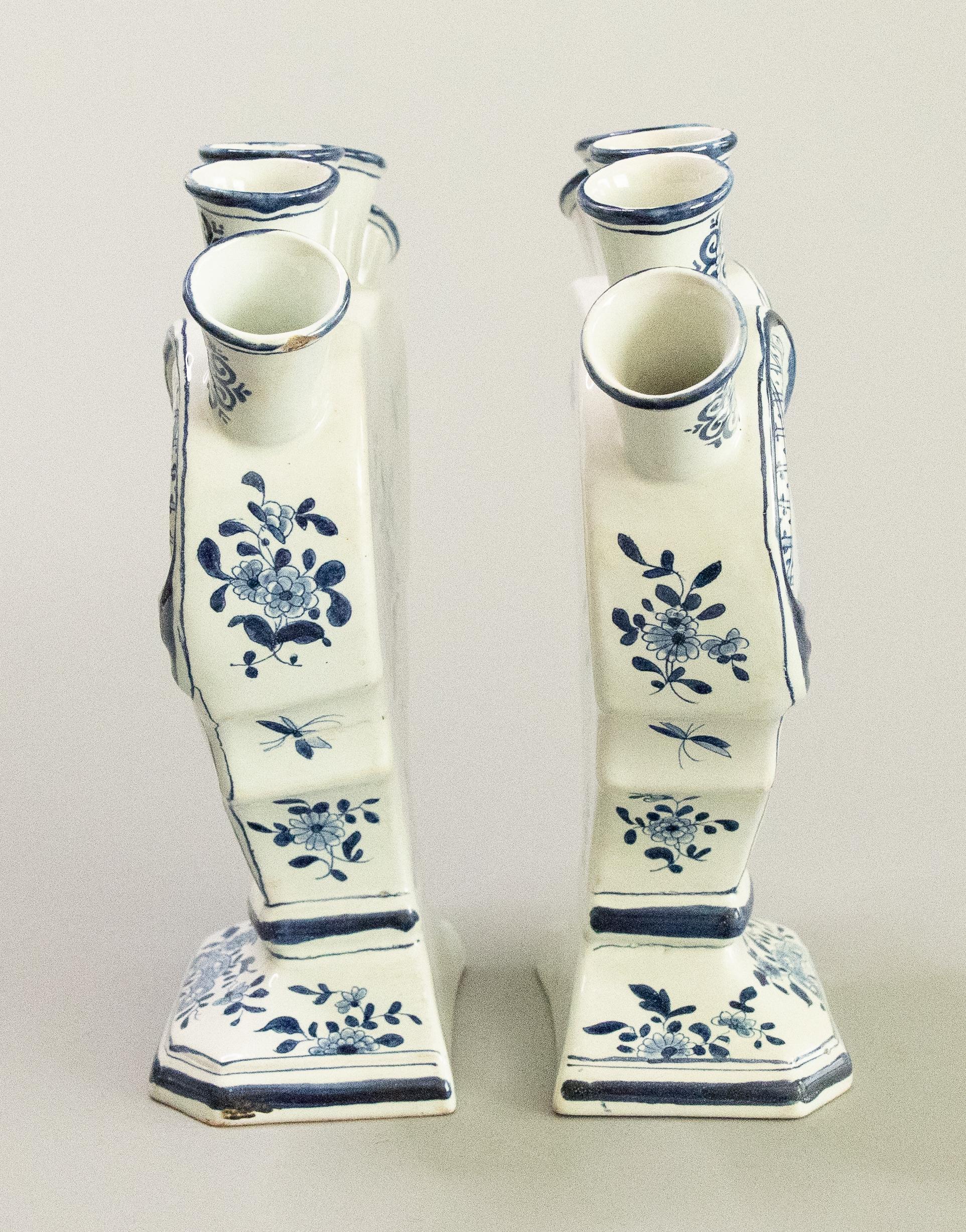 A rare pair of antique 19th Century Dutch Delft faience five finger heart-shaped tulip vases or tulipieres. Maker's marks on reverse. These lovely tulip vases are decorated with fine hand painted figures, flowers, and pagodas in a Chinoiserie style.