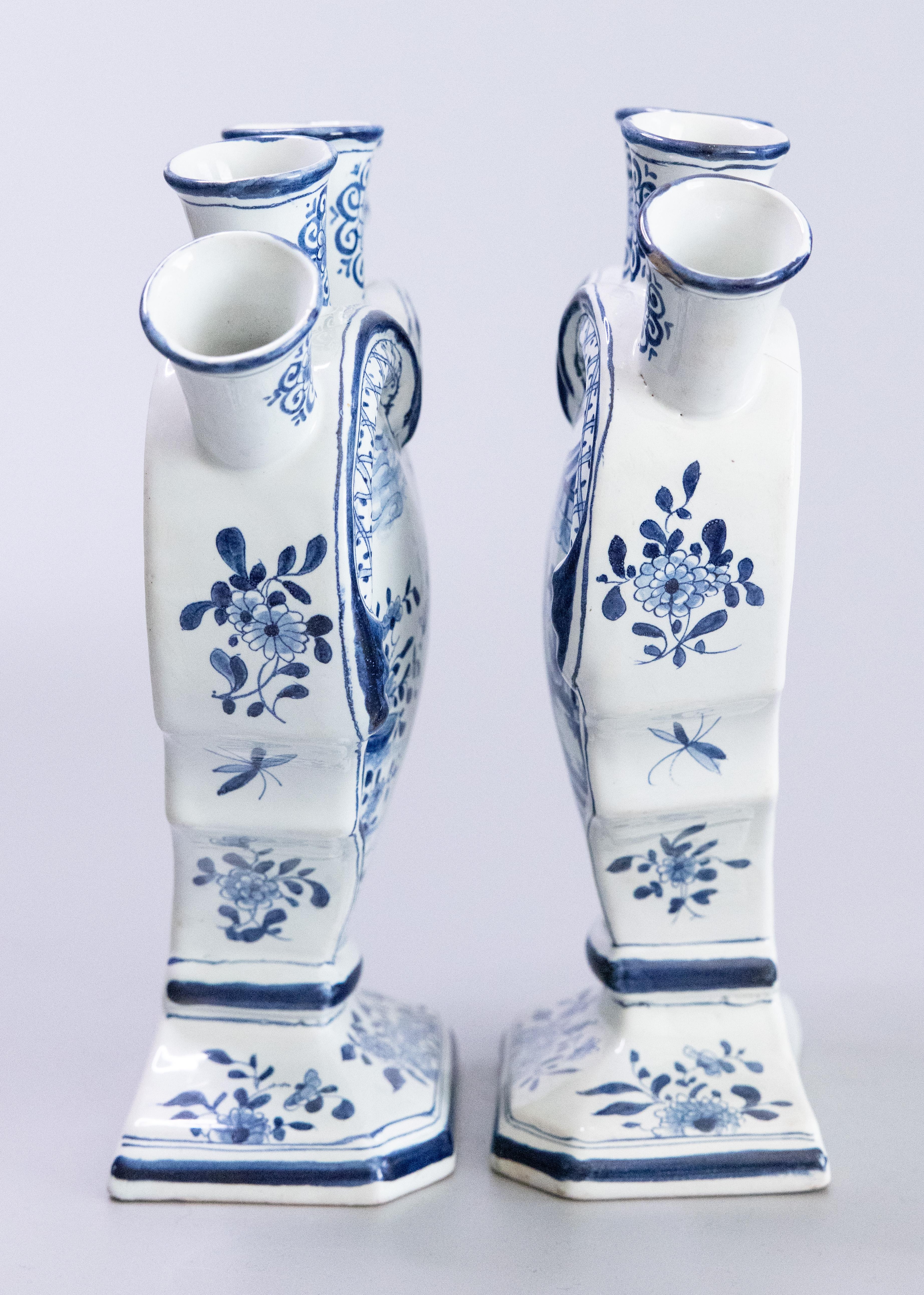 A rare pair of antique 19th Century Dutch Delft faience five finger heart-shaped tulip vases or tulipieres. Maker's marks on reverse. These lovely tulip vases are decorated with fine hand painted figures, flowers, and pagodas in a Chinoiserie style.