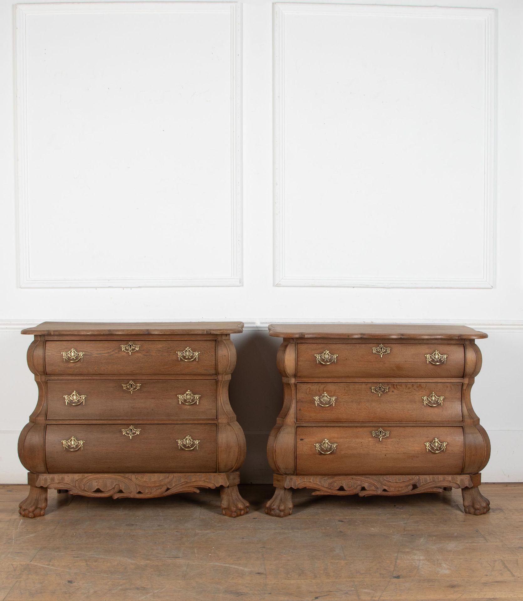 Pair of late 19th Century Dutch bombe commodes.
Solid oak with a warm mid colour and fine cast brass fittings. With carved details to the base and feet.
Circa 1890.