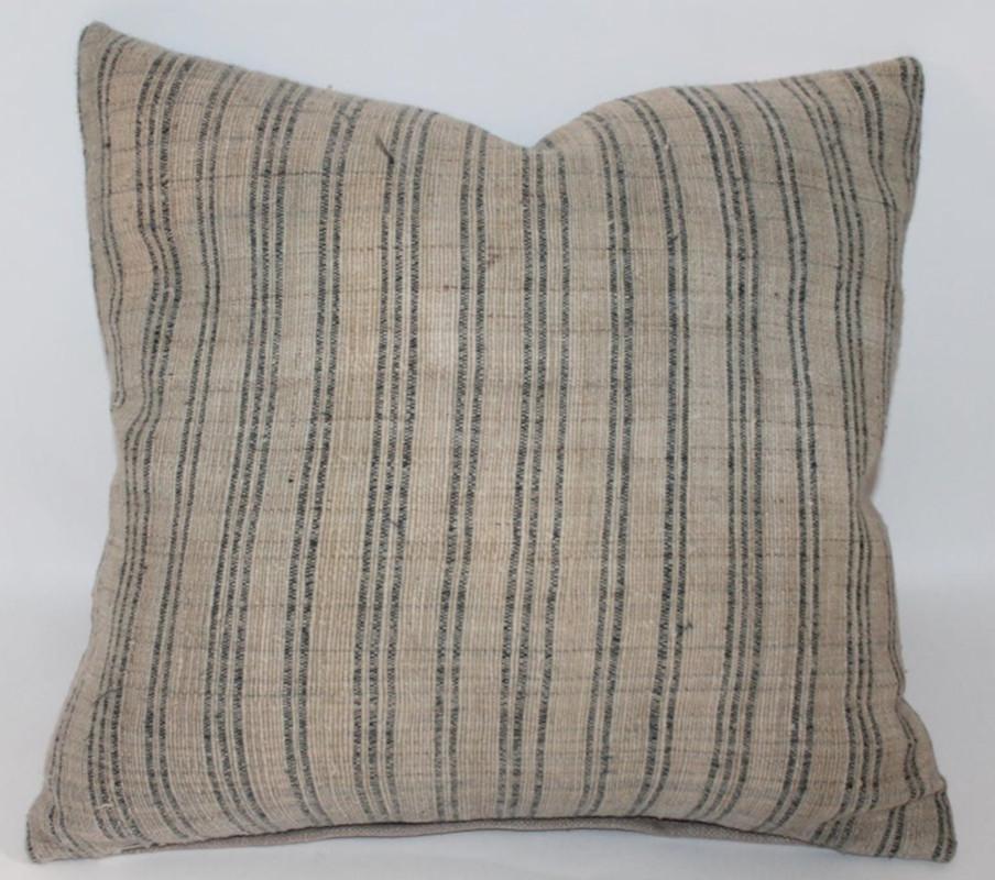 These early homespun striped linen pillows have natural tan cotton linen backings. There are two pairs in stock.