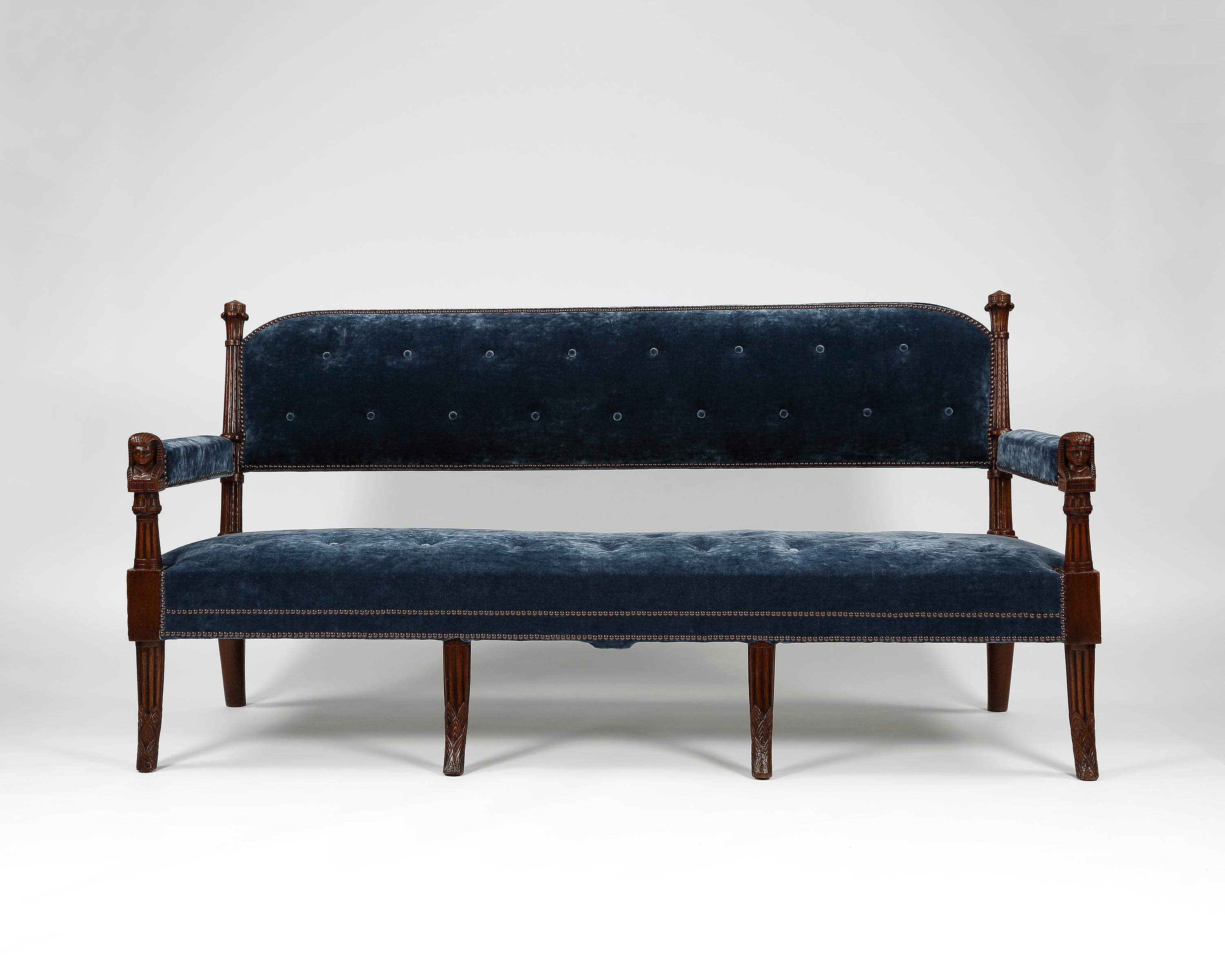 A fine pair of settees in the Egyptian design. The arms are headed with carved Egyptian style heads. Raised on four carved up-rights and upholstered in a velvet by Colefax and Fowler.
Similar furniture designs and furnishings can be seen at