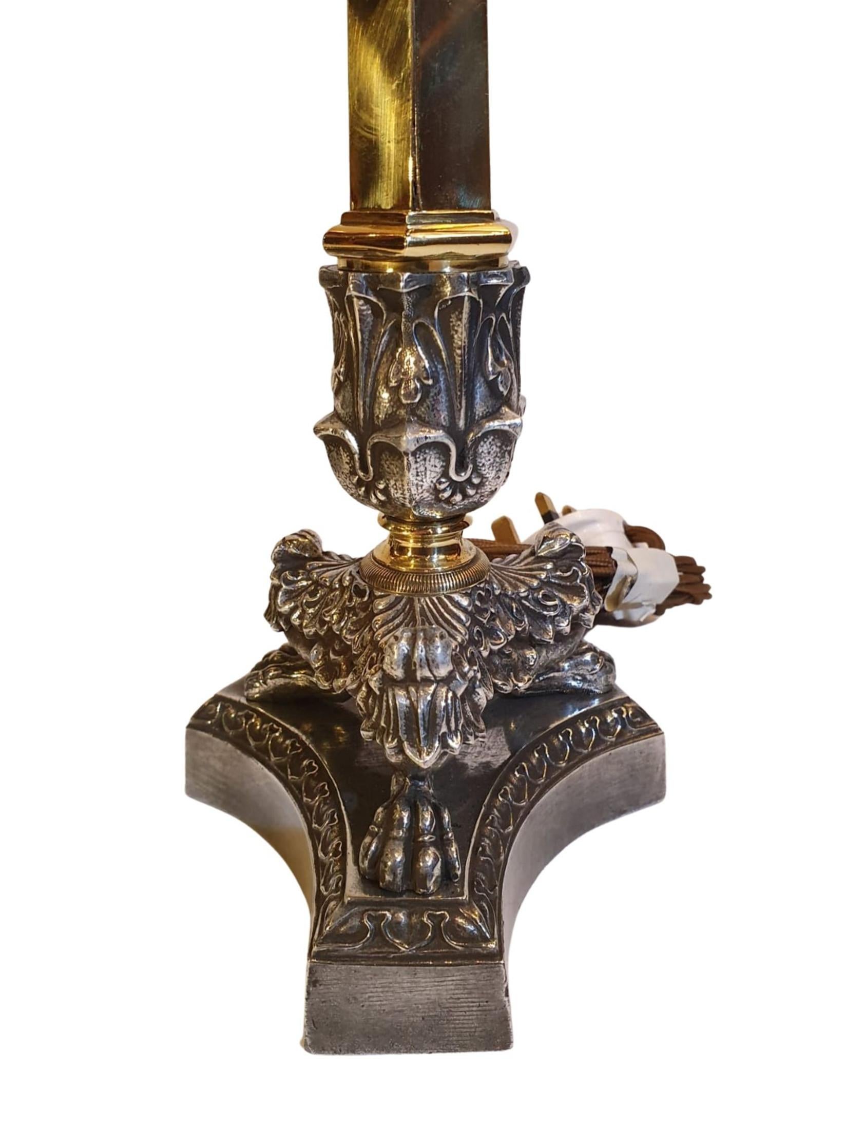 A stunning pair of 19th century Empire style candlesticks in brass and pol-ished steel converted to table lamps. Beautifully decorated with ornate acanthus leaf motif detail raised over hexagon columnar stem with scroll and foliate motif detail at