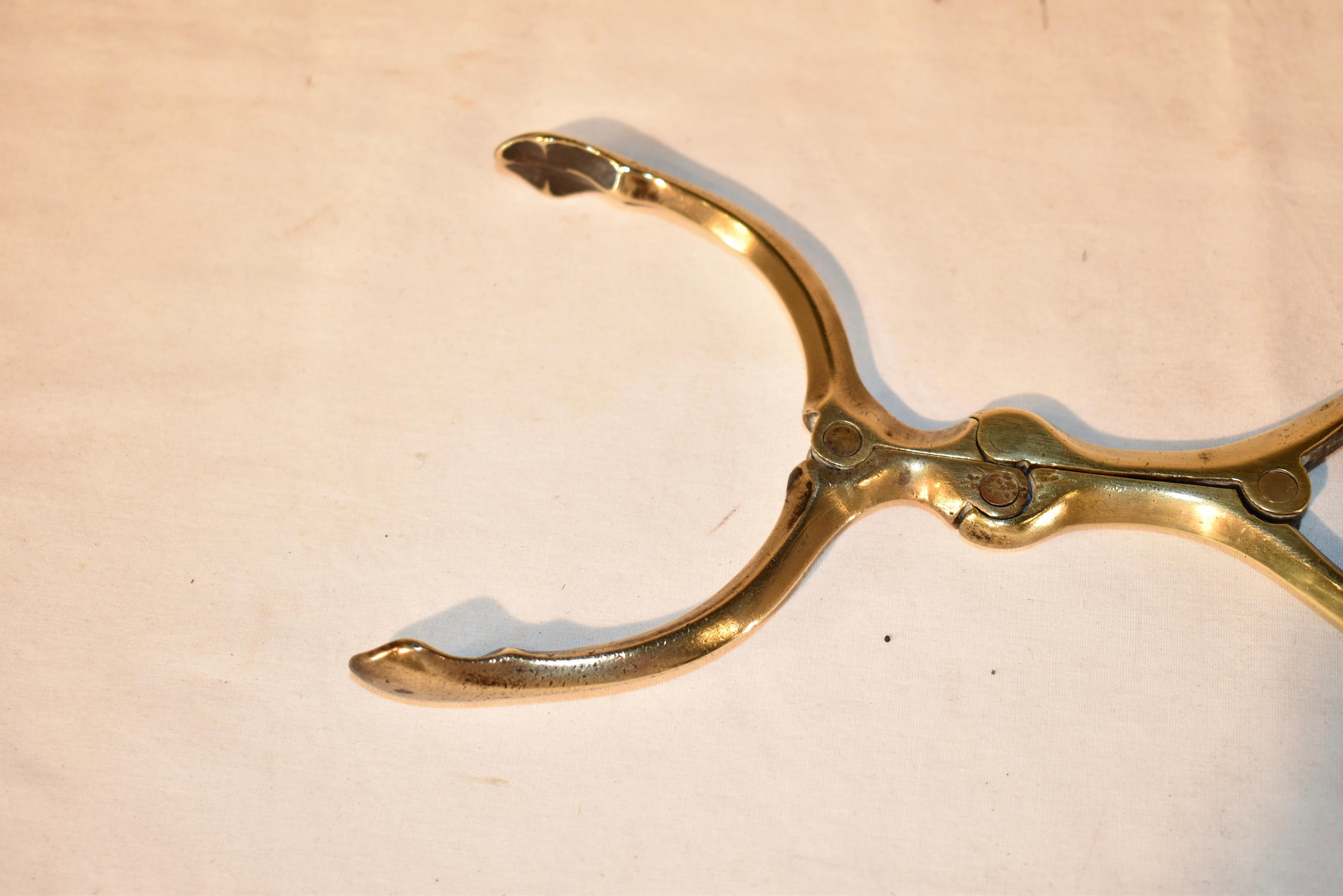 19th century  pair of English brazier tongs, made from brass.  These are truly wonderful, and are so unusual!  Once used to place hot coals in a hand-warming brazier, this Victorian implement was hand wrought from brass with function and lovely form