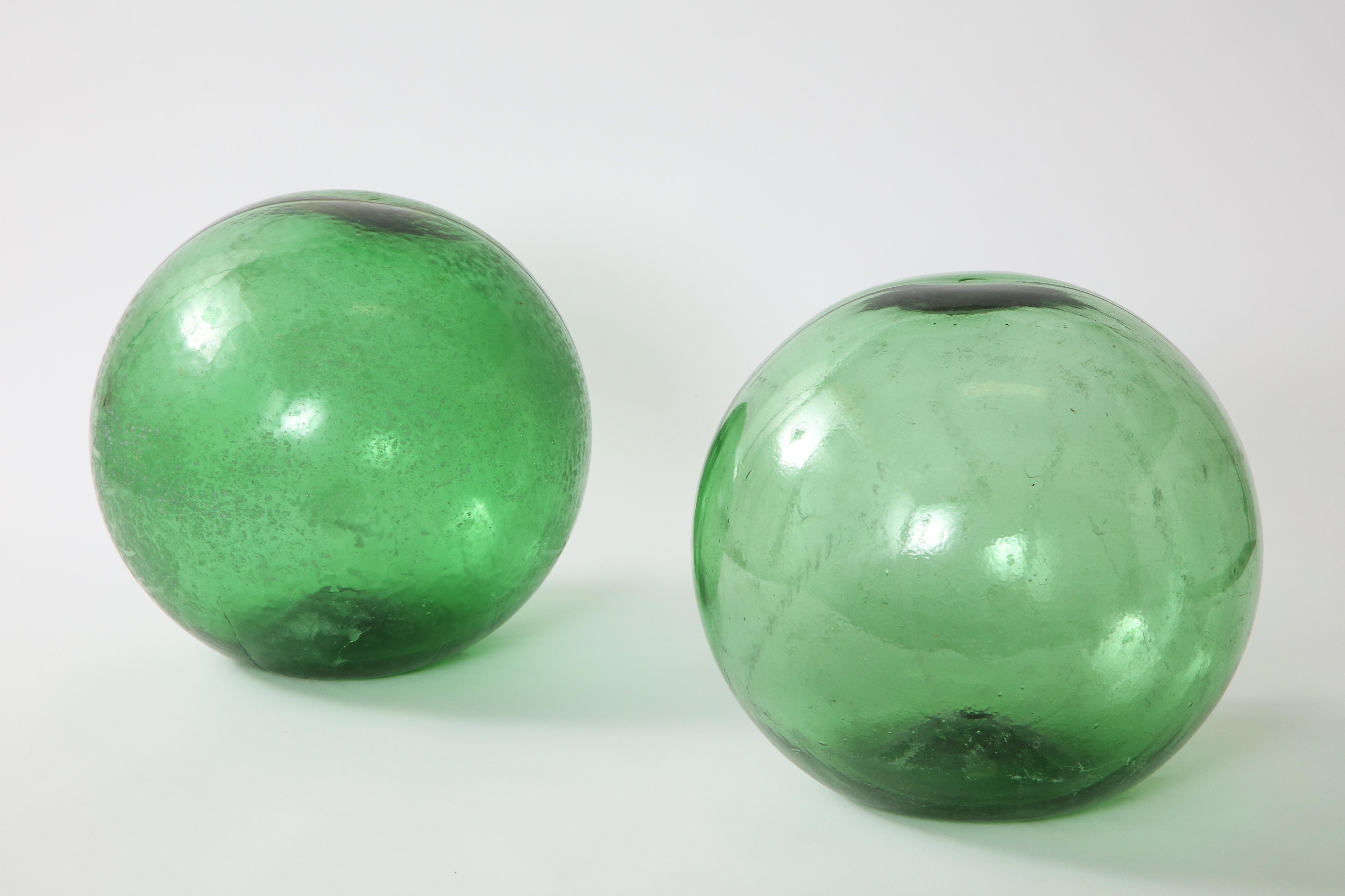 Pair of 19th century green hand blown glass orbs from England.