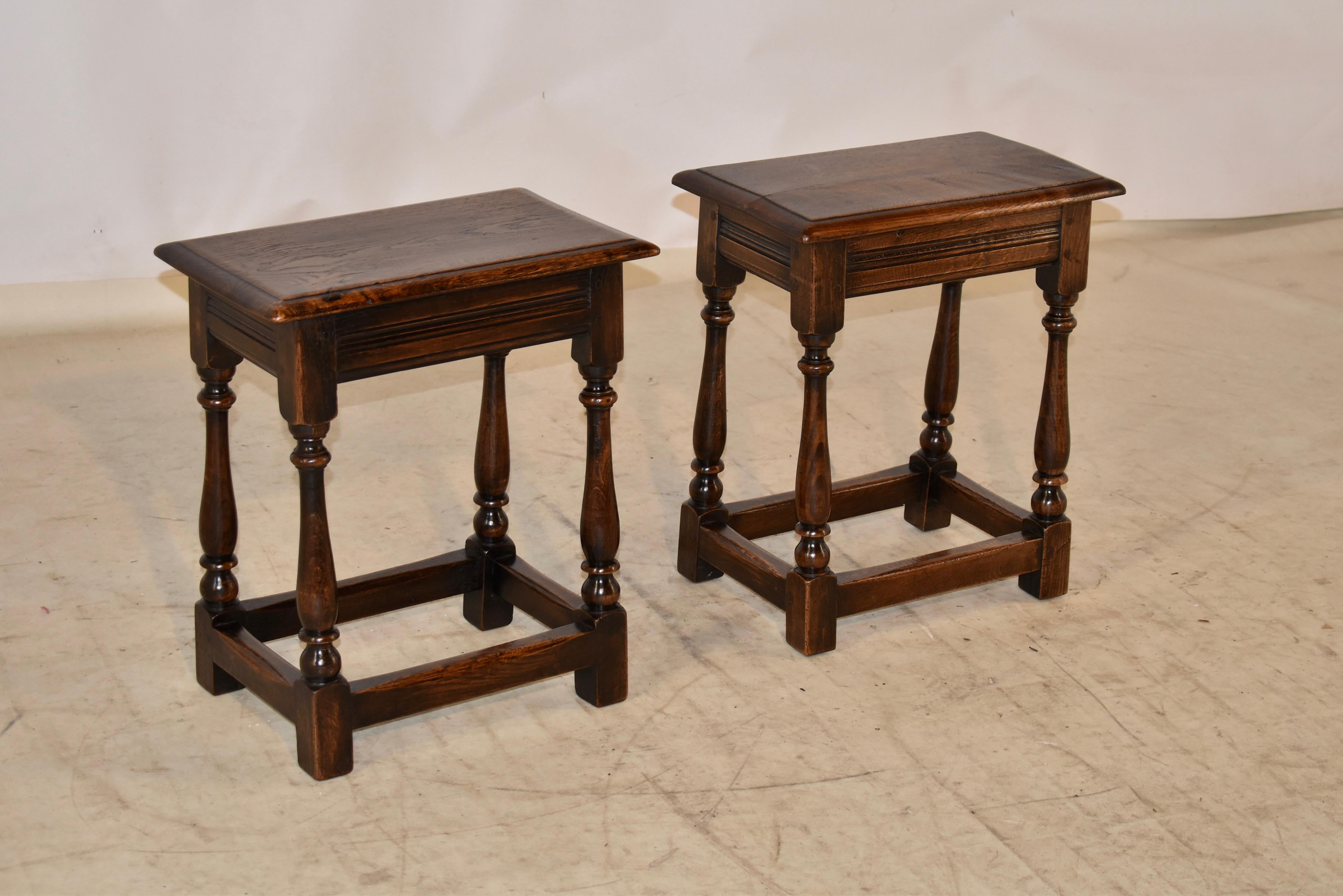 Pair of 19th century oak joint stools from England. The tops are nicely grained and have beveled edges, following down to routed aprons and supported on hand turned legs, joined by simple stretchers. These have a wonderful original patina in a warm