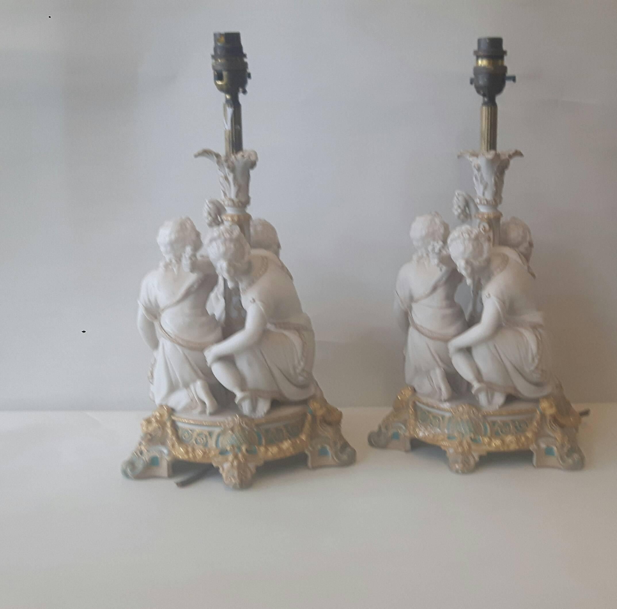 A very elegant pair of lamps, English, probably Copeland or Minton, in the French manner, Parian ware (unglazed porcelain). The group reminds one of summer, where two figures are eating grapes and another is holding a garland of flowers.
The group