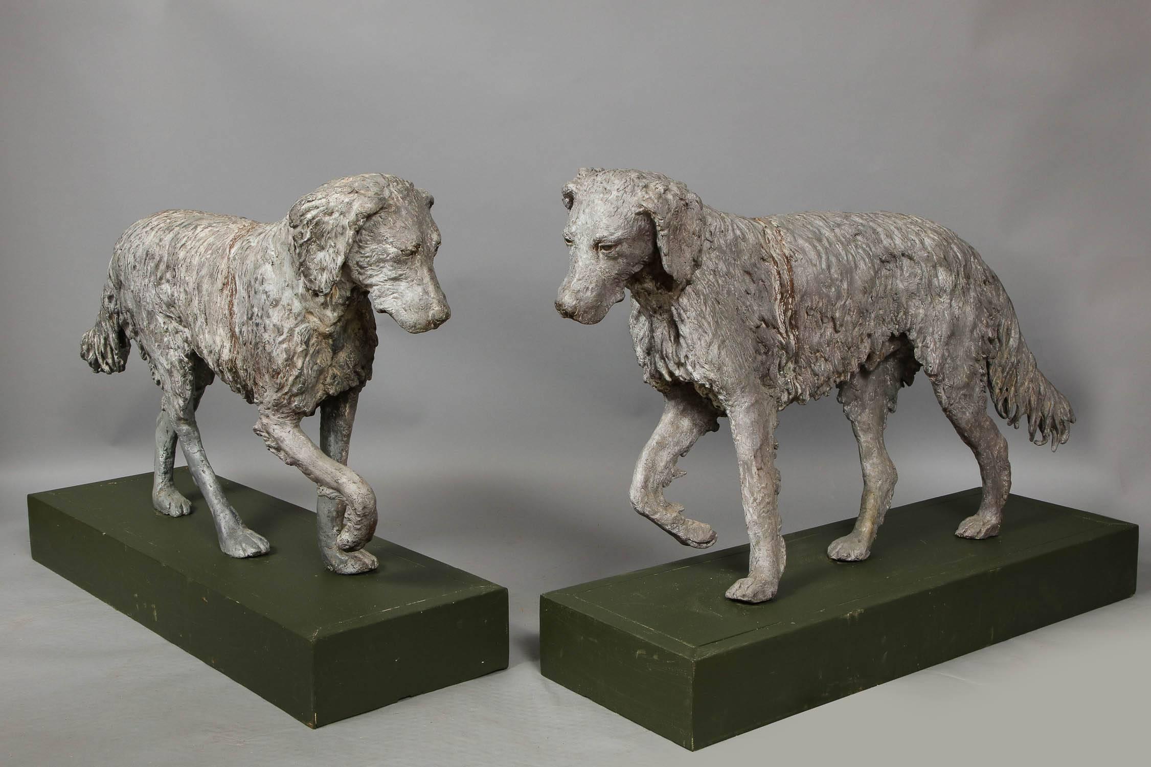 Unusual pair of lifesize English late 19th century sculpted lead dogs with raised front paws, and having expressive faces and well detailed coat. 

Note, stances of the dogs are very similar, but are not mirror images of one another. Bases now