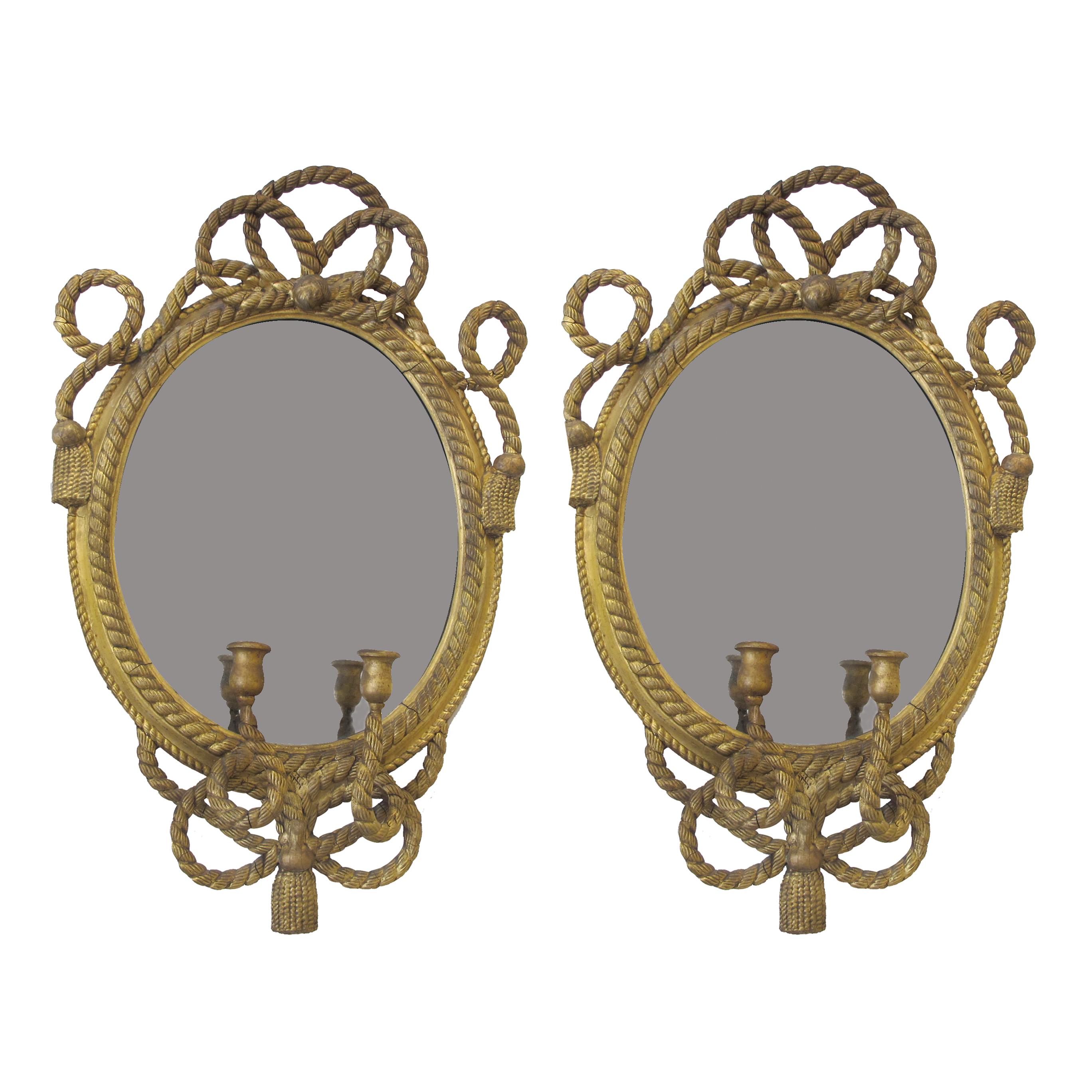 Pair of antique, early 19th century, maritime, gilt carved wood mirrored wall sconces with ornate nautical gilt ropes and two candle holders on each one. The original mirrored glass shows signs of age-related foxing which adds charm and character to