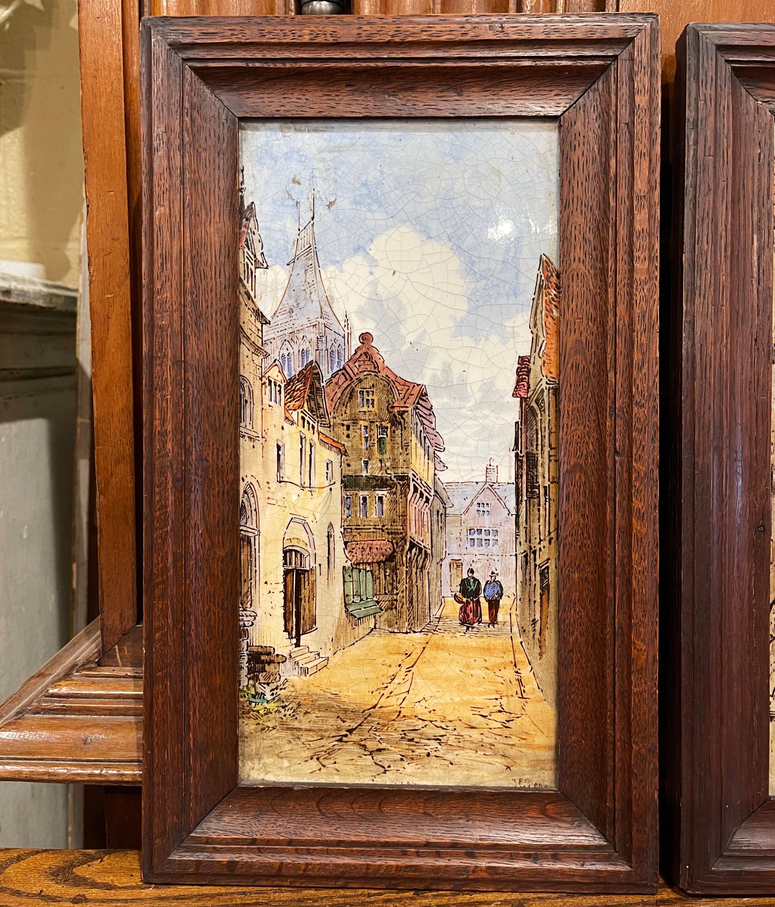 Crafted in England circa 1880, and set in the original carved oak frames, each plaque is hand painted and stamped on the back Minton, London, England. Each porcelain, signed by the artist J.E. Dean, depicts a British street scene with people