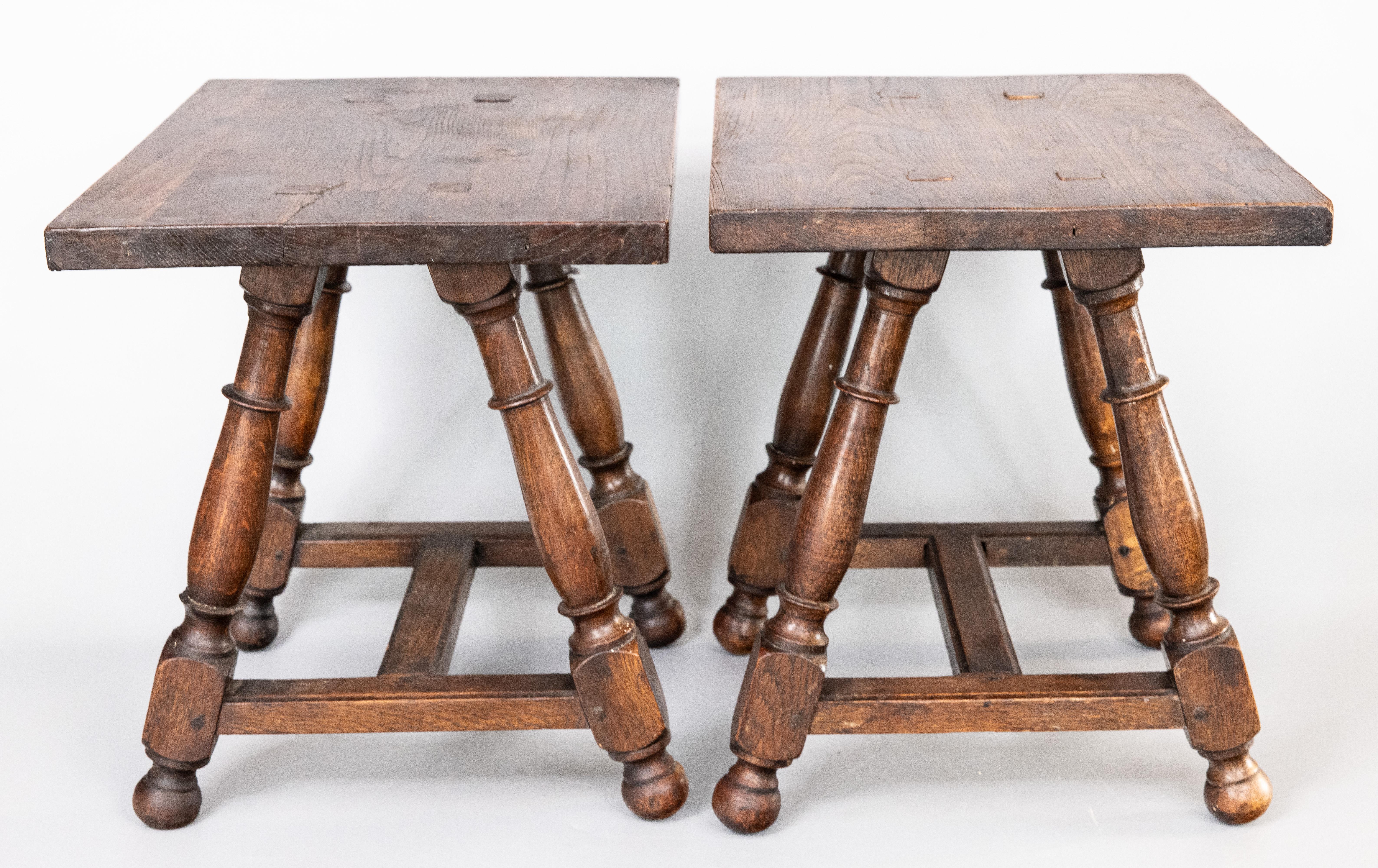 A superb pair of antique 19th Century English oak pegged joint stools or side tables with hand turned splayed legs. These charming stools have a simple shape with clean lines, perfect for the modern home. They would be great for extra seating and