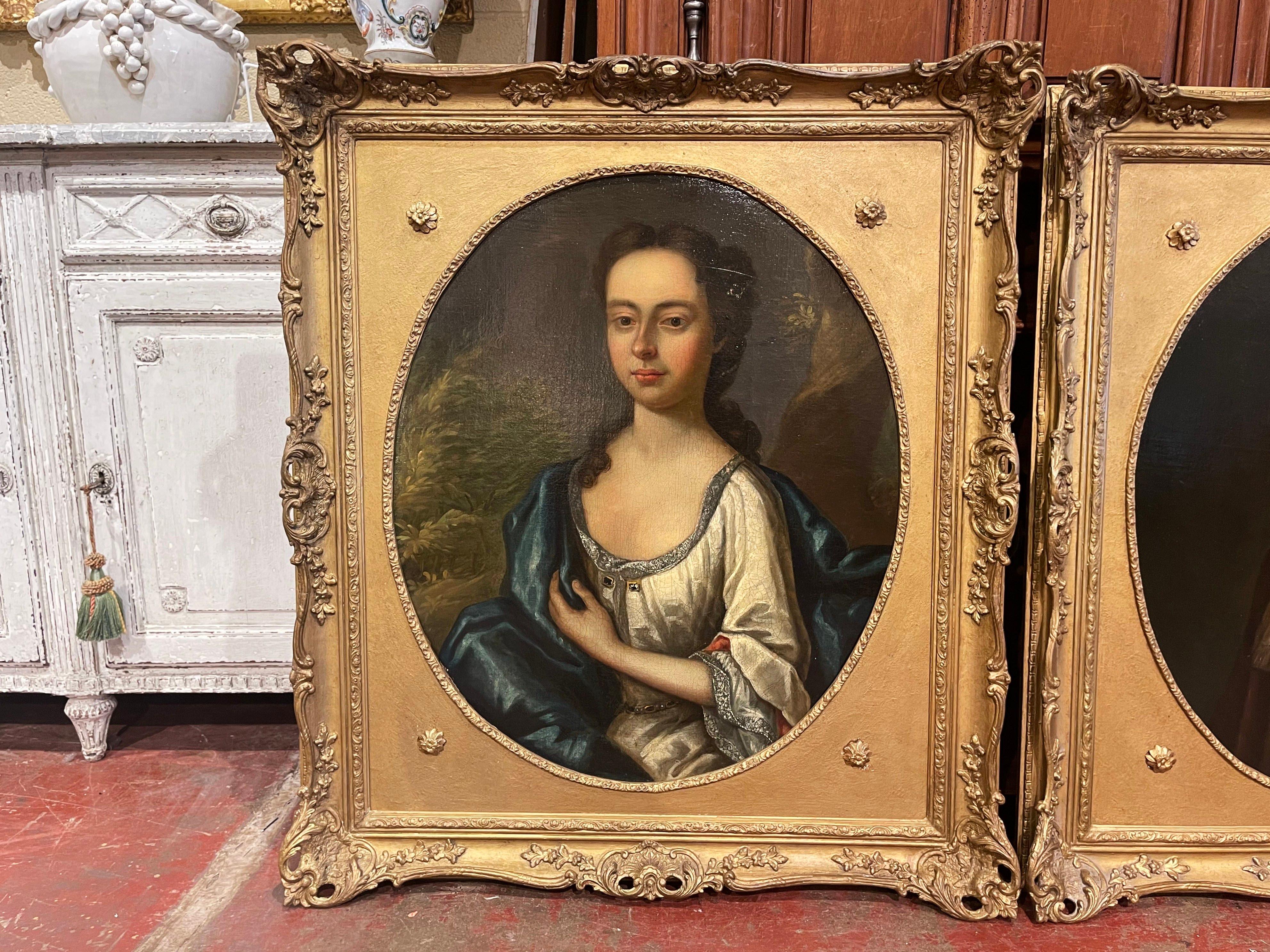 Decorate a living room or study with this exquisite pair of antique paintings. Crafted in England circa 1860 in the Baroque slyle from the school of Godfrey Kneller, and set in the original carved gilt frame, each oval portrait composition is at