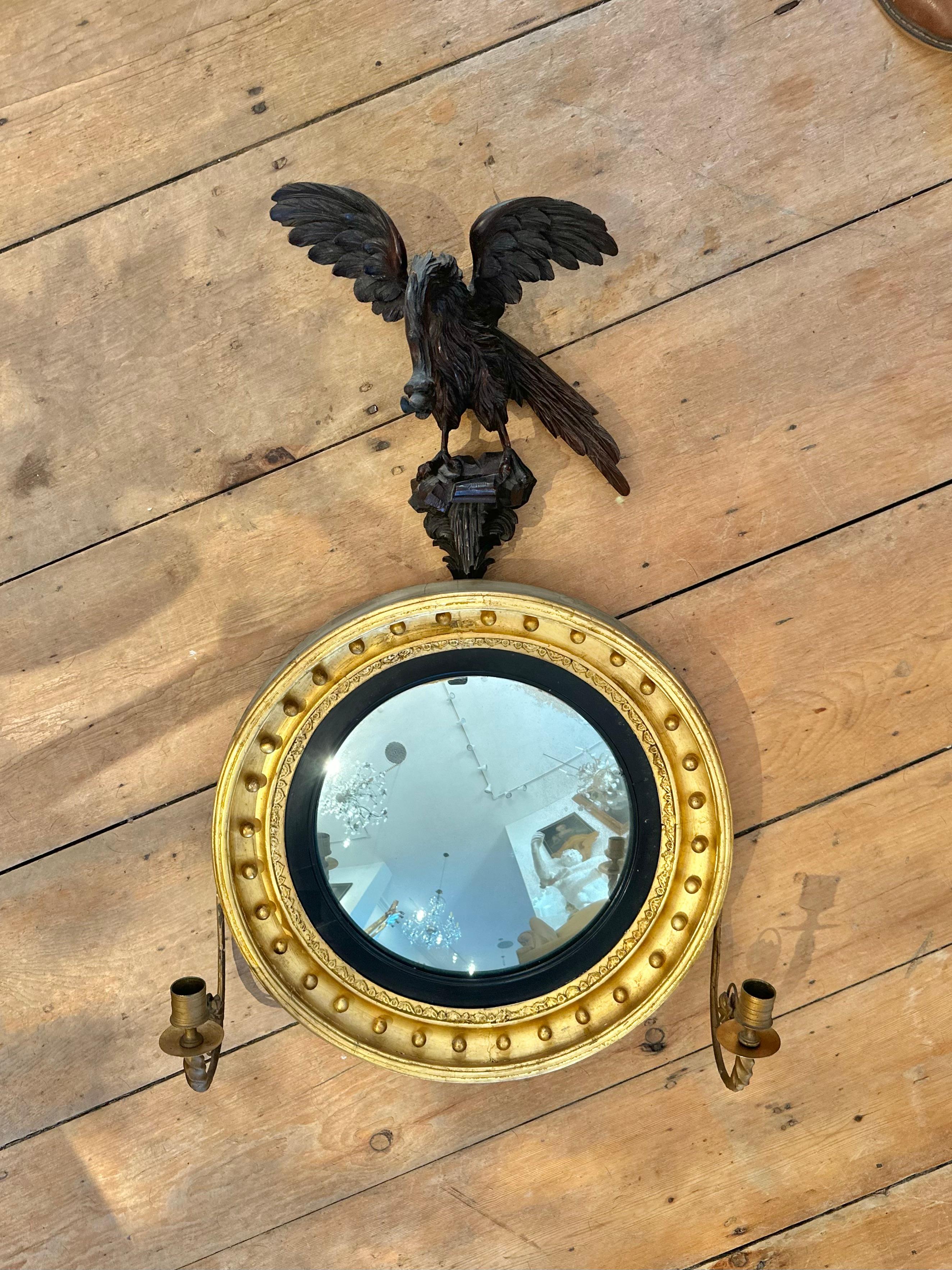 Pair of 19th Century English or American Regency Convex Mirrors.  Of Small Size.  Girandole Arms. Perched Eagle Finials.  Original gilding.  Original glass 