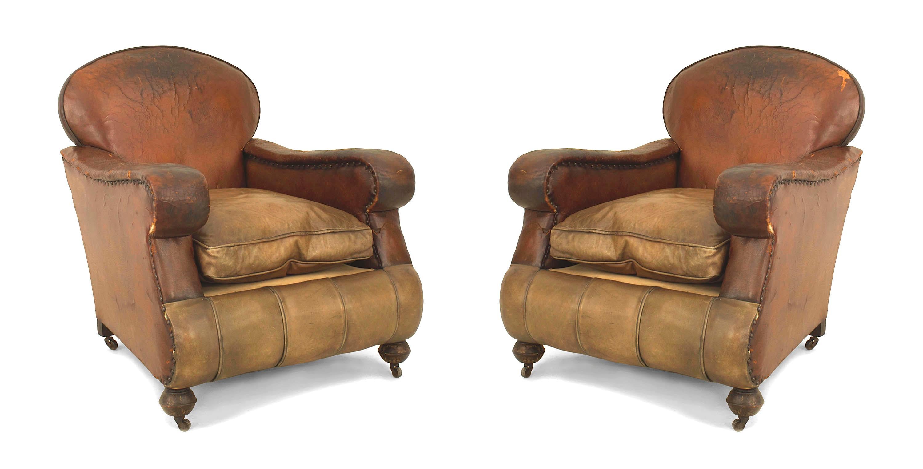 Pair of English Victorian over size brown leather club chairs with a cushion seat and rounded back (condition of leather AS IS).