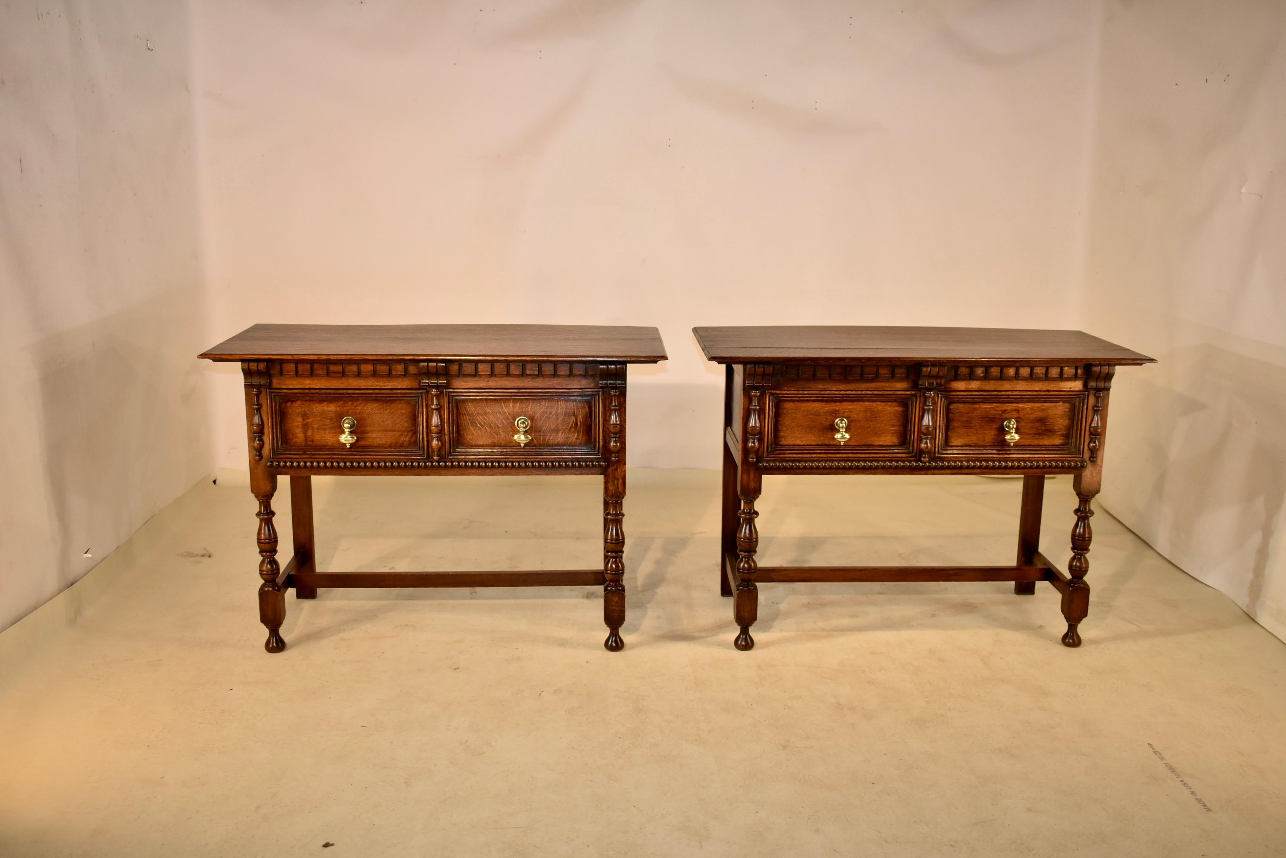 Rare pair of 19th century oak sideboards from England. The tops are nicely figured and follow down to simple paneled sides and two paneled drawers in the front. The sideboards have lovely dentil molding over the drawers and they are flanked by