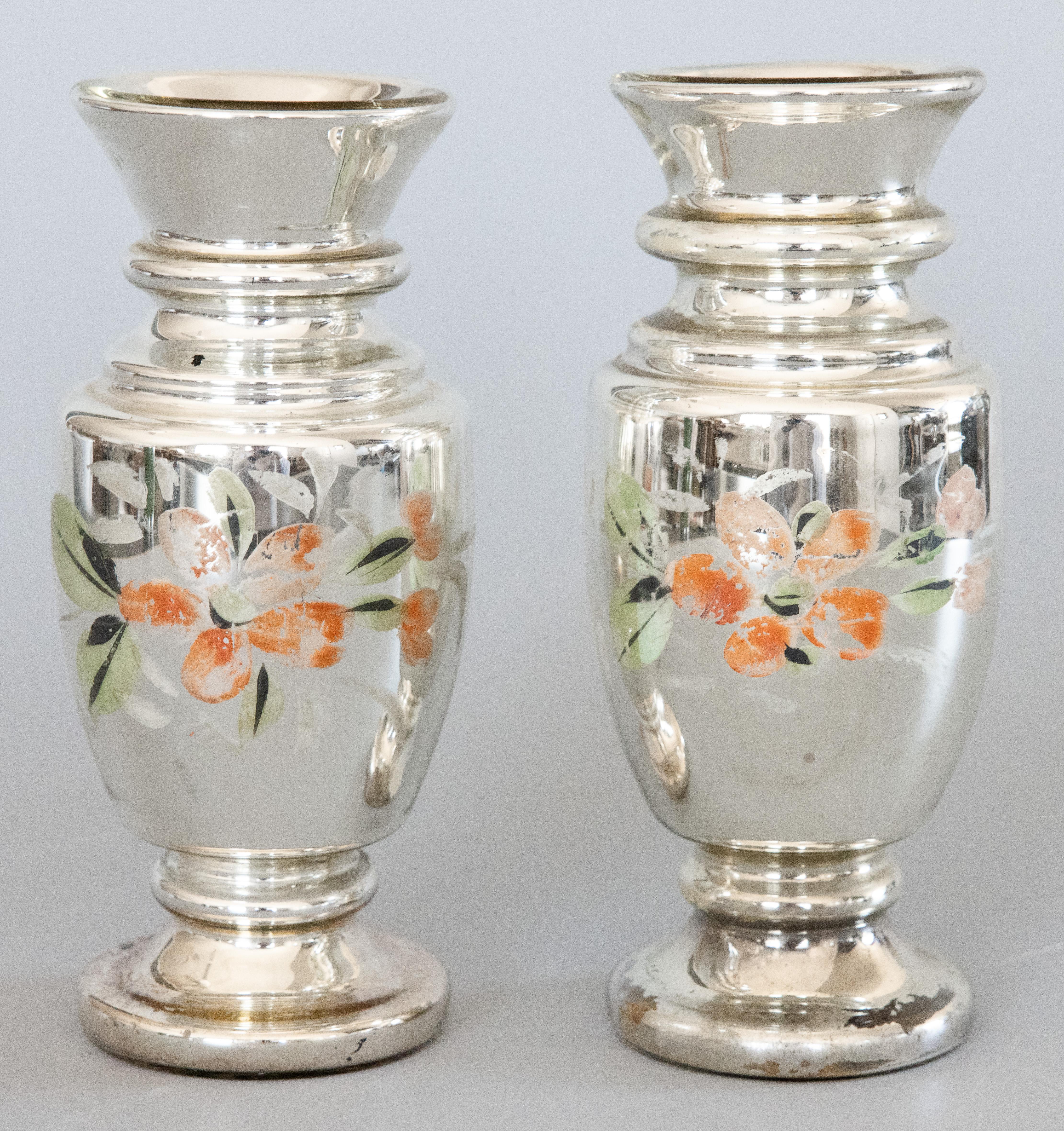 A lovely pair of authentic antique 19th-Century hand blown mercury glass decorative vases from England. These stunning vases have stylish shapes with hand painted floral designs in a beautiful patina and would be the perfect room accent
