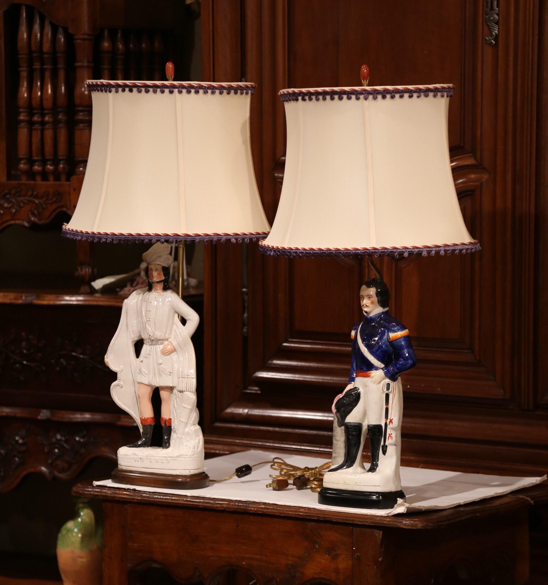 Place these tall decorative Majolica lamps in a living room or on bedside tables; created in England, circa 1890, the porcelain Staffordshire figurines depict two important figures of France and Switzerland; Louis Napoleon and Guillaume Tell. Both