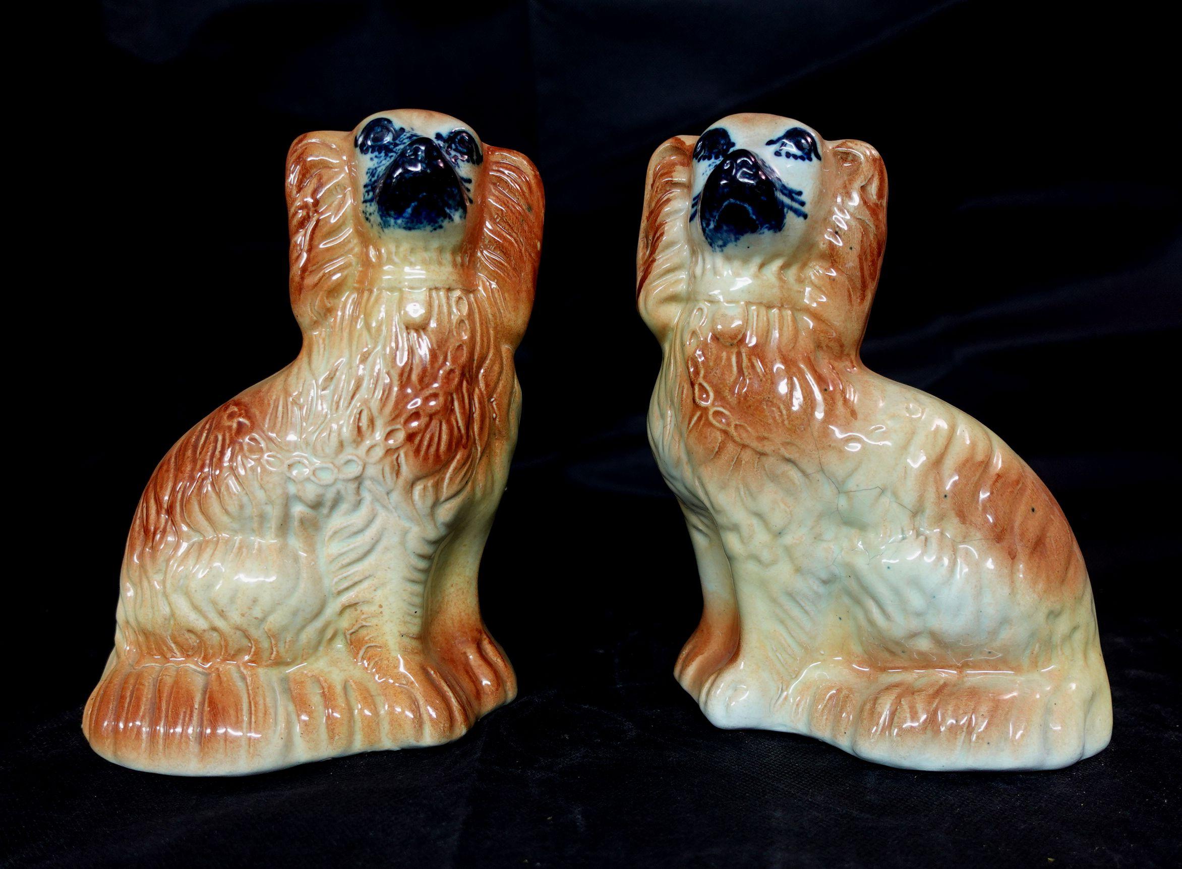 A fine pair of antique 19th-Century English Staffordshire mantel dogs. These charming dogs are hand-painted with lovely details and sweet faces. 


 