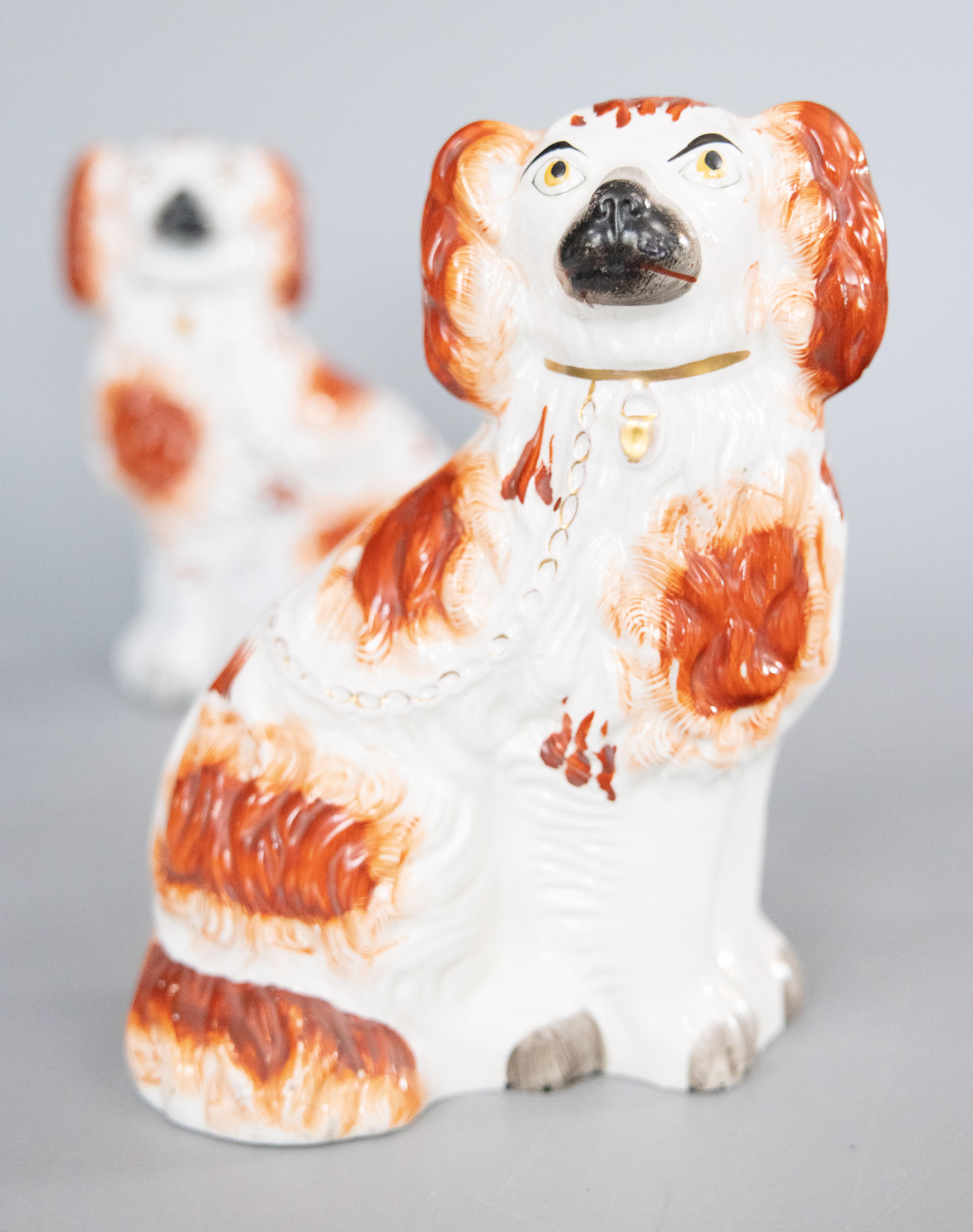 A fine pair of antique 19th-Century English Staffordshire russet Cavalier King Charles Spaniel mantel dogs. These charming dogs are hand painted with lovely gilt details and sweet faces. They are the perfect Victorian pair of dogs for your mantel,