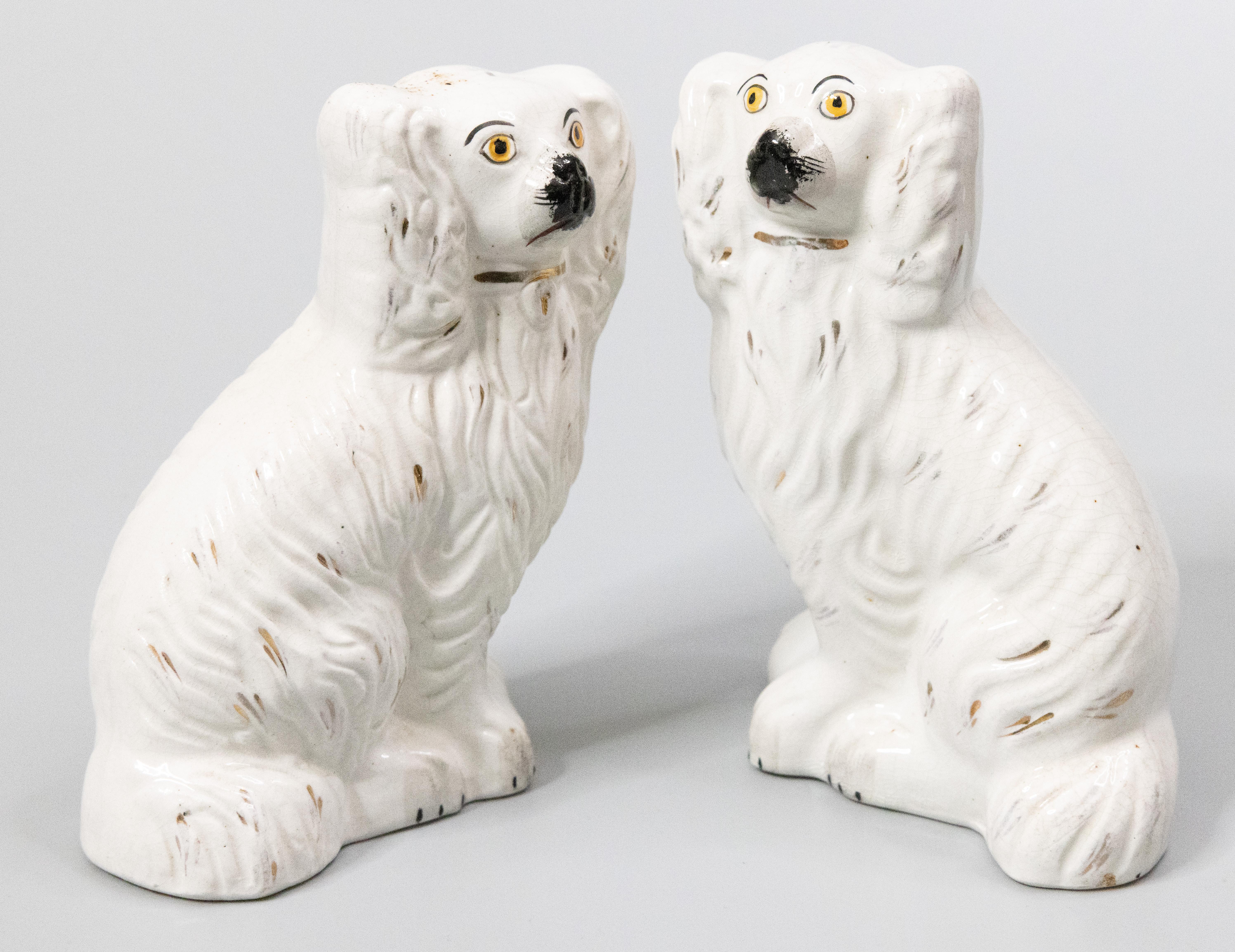 A fine pair of antique 19th-Century English Staffordshire mantel dogs. These charming dogs are hand painted with lovely gilt details and sweet faces. They are the perfect Victorian pair of dogs for your mantel, bookcase, or table.

 