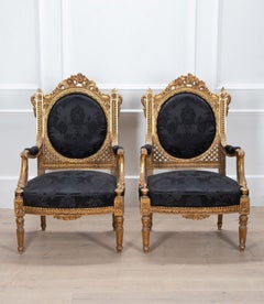 Pareja de sillones ingleses del siglo XIX tapizados y dorados