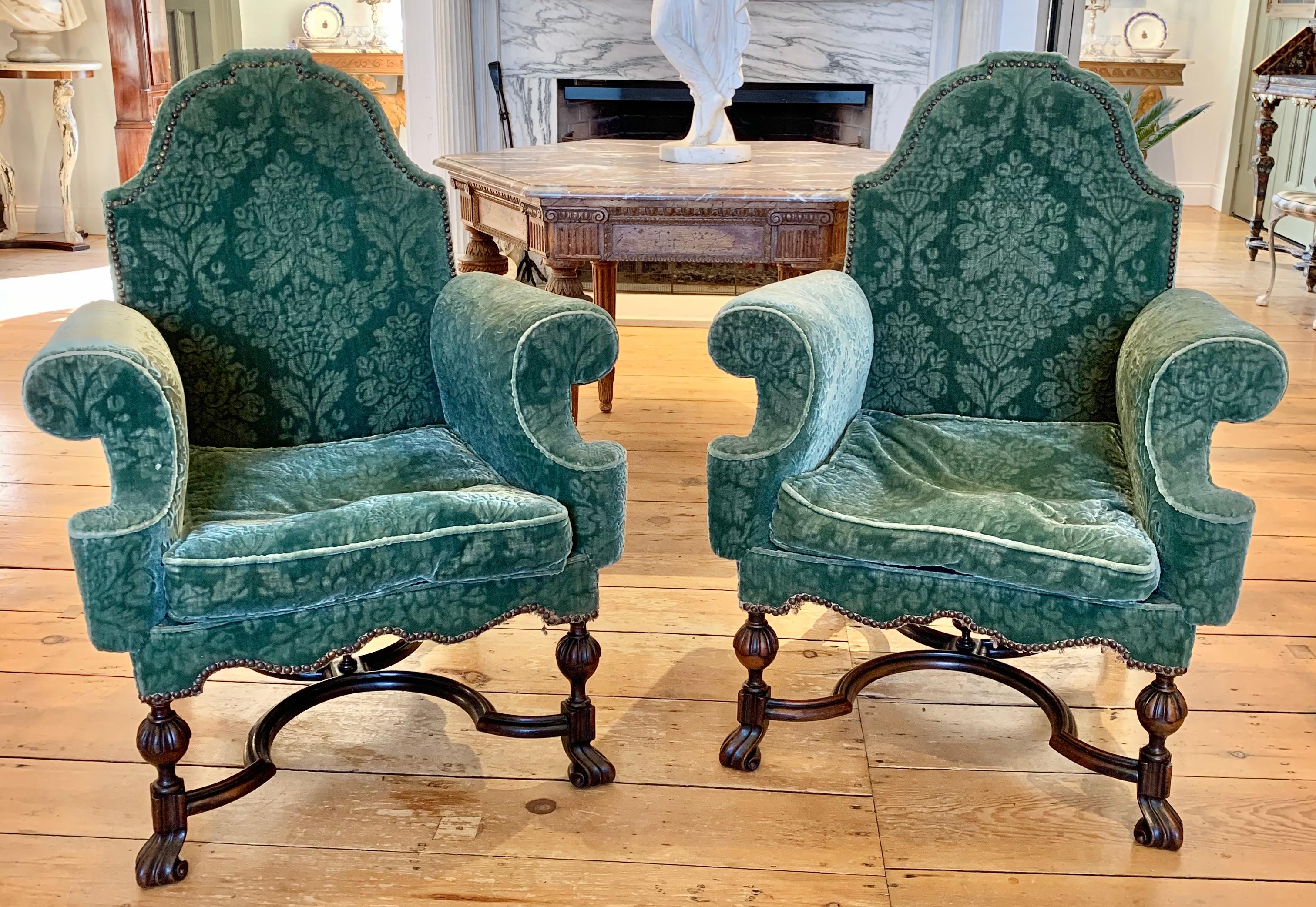 Pair of Jacobean walnut rolled arm armchairs. Carved ball form legs with Spanish feet and serpentine stretchers. Comfortable and sturdy. Ready for reupholstering.

Ex Collection North Shore Massachusetts, Prides Crossing.