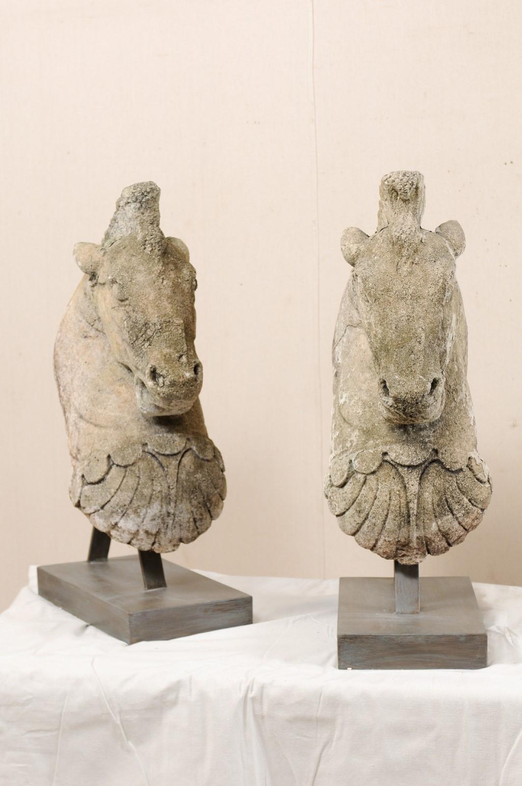 A pair of 19th century European sculptural horse heads of cast stone, mounted on custom stands. These fabulous art pieces, standing just shy of 3 feet in height, have been custom fashioned from a pair of 19th century cast-stone horse heads, which