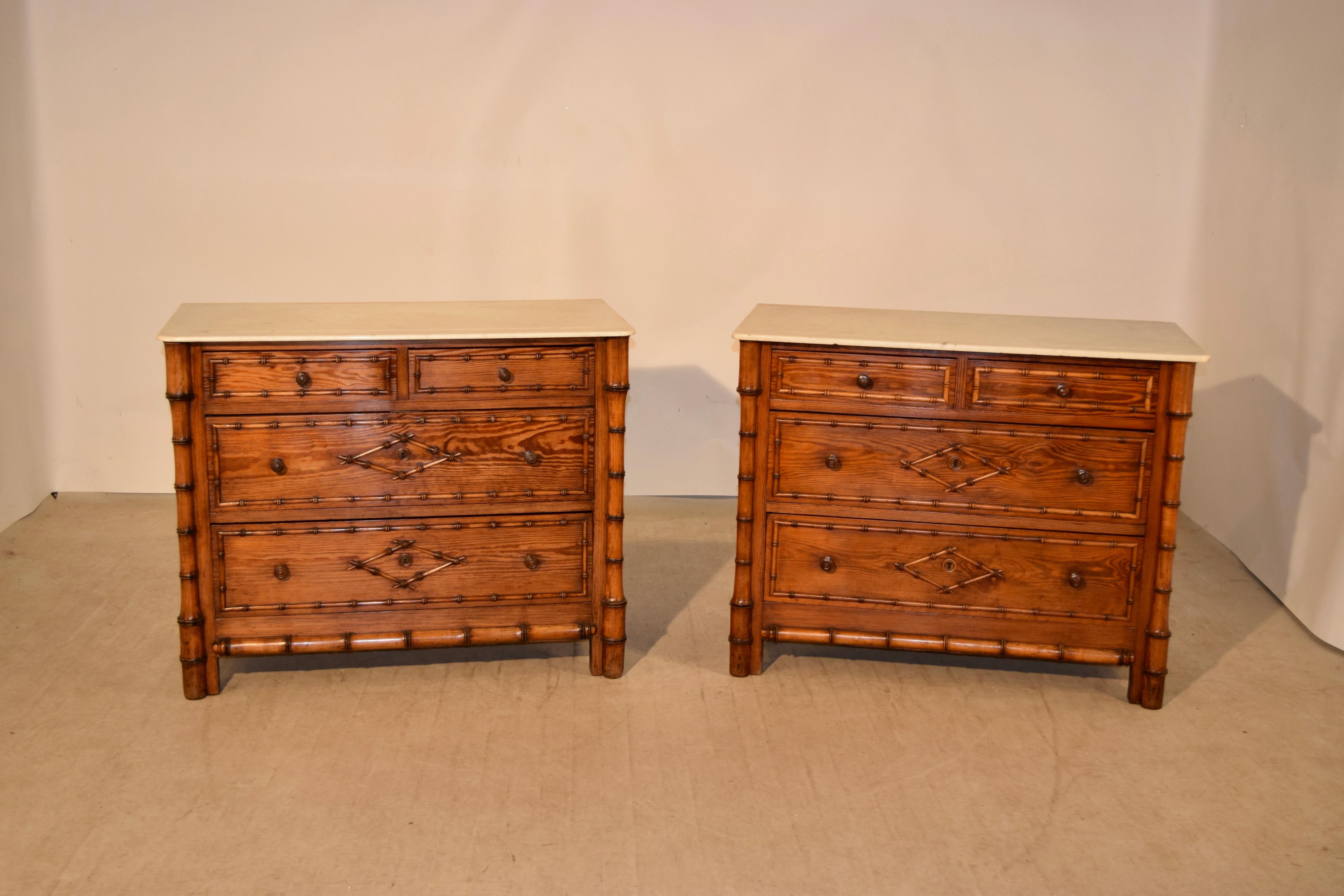Pair of 19th century chests of drawers with faux bamboo decoration from France. The tops are made from marble, following down to cases made from cherry and pitch pine. They have two smaller drawers over two larger drawers and the drawer fronts are