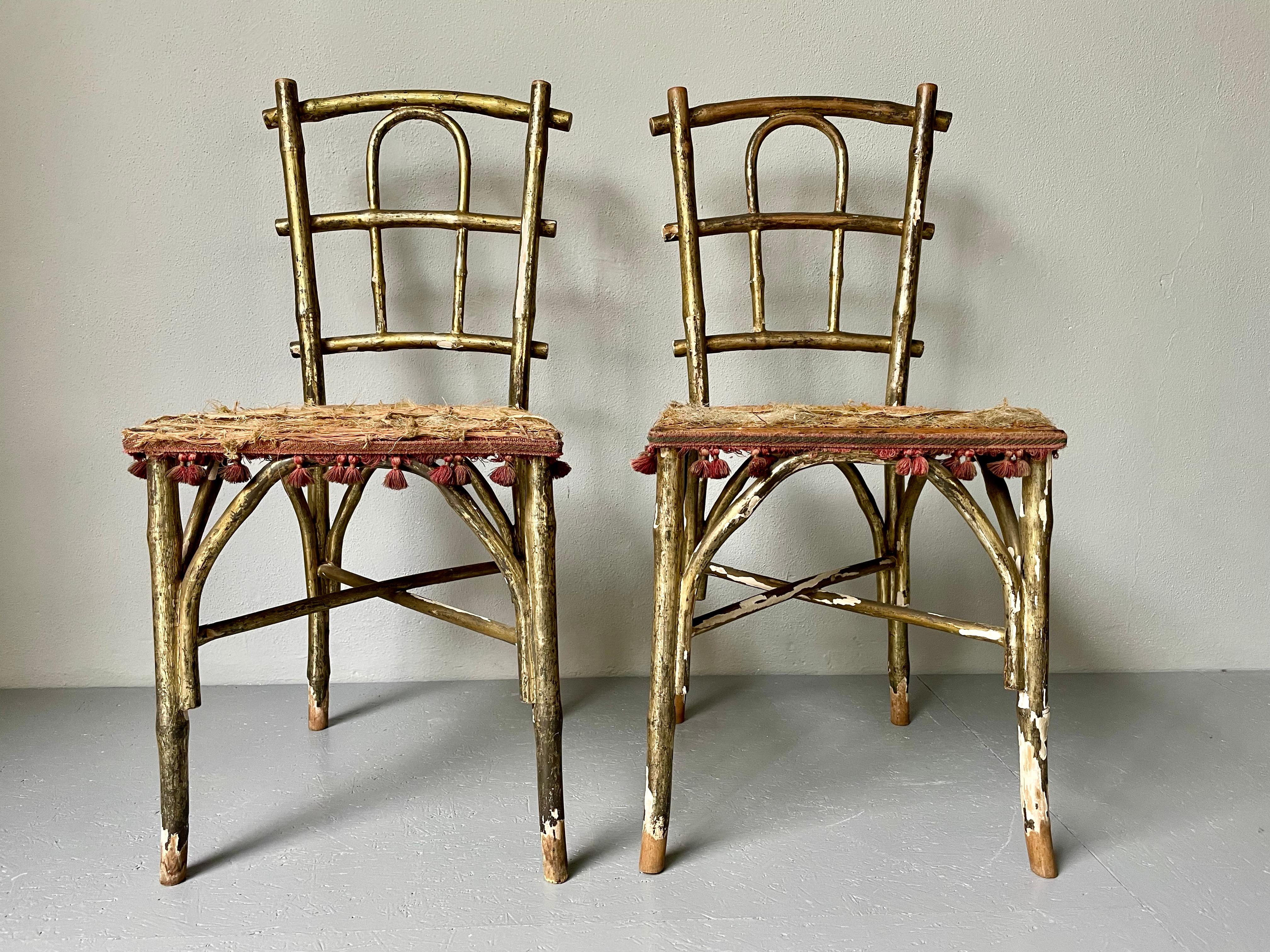 19th Century bentwood parlor chairs by Thonet. Beautiful gold patina & faded fabric. Both chairs show heavy signs of their age, flaking gold patina, washed out seat fabric & yet the charm remains. Both chairs have attribution marks from Thonet.