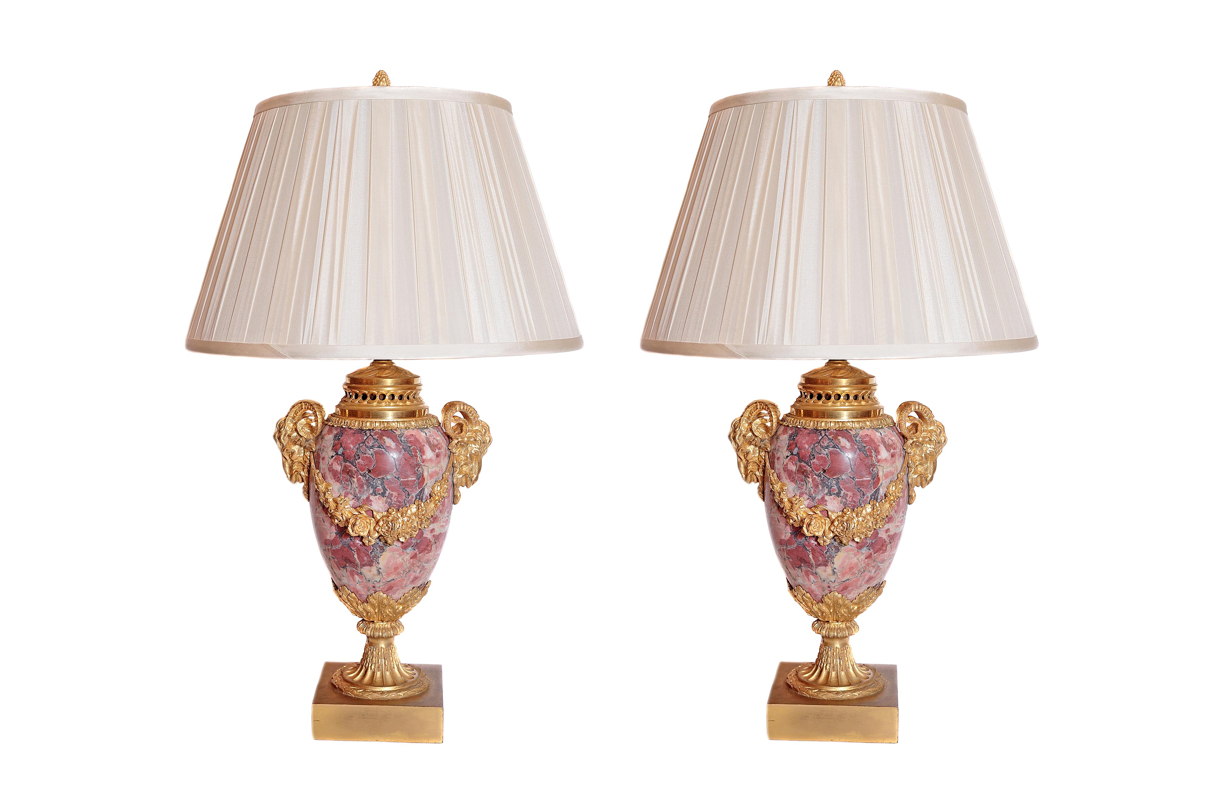 A fine pair of 19th century French gilt bronze and breche Violette marble urn lamps. Ram's head details.