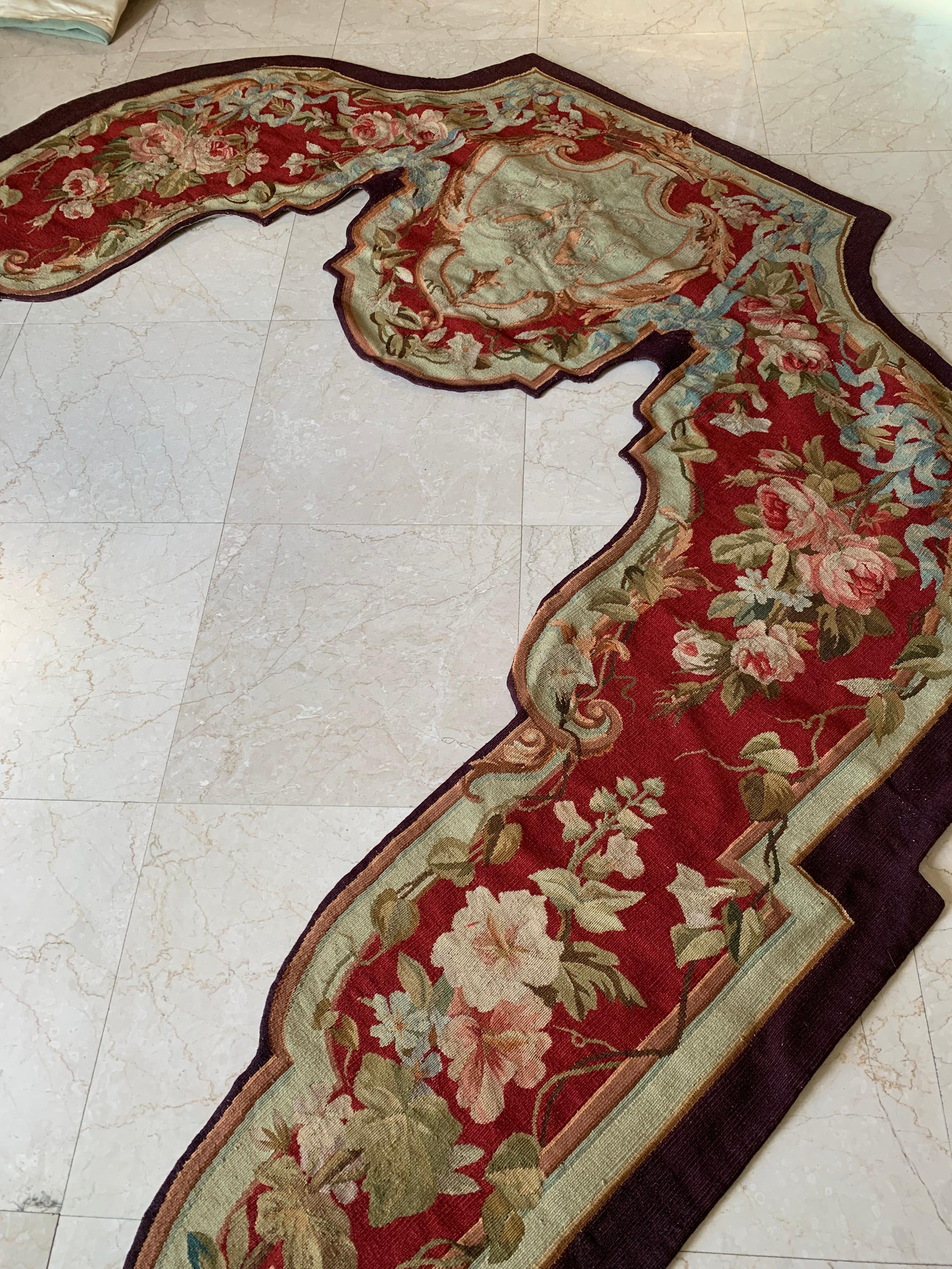 Called portière, these antique wall hanging tapestries were handwoven in Aubusson, France in the 19th Century. They both feature floral and foliage decor in a deep red and beige palette. Portière tapestries were traditionally used in French chateaux
