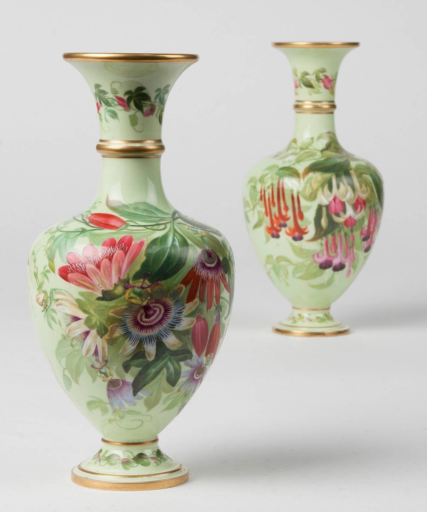 A couple of porcelain vases made by Copeland. The vases were made circa 1860, which can be seen from the used mark on the bottom.
The two vases are different, they are painted with various types of flowers, including clematis, fuchsias and