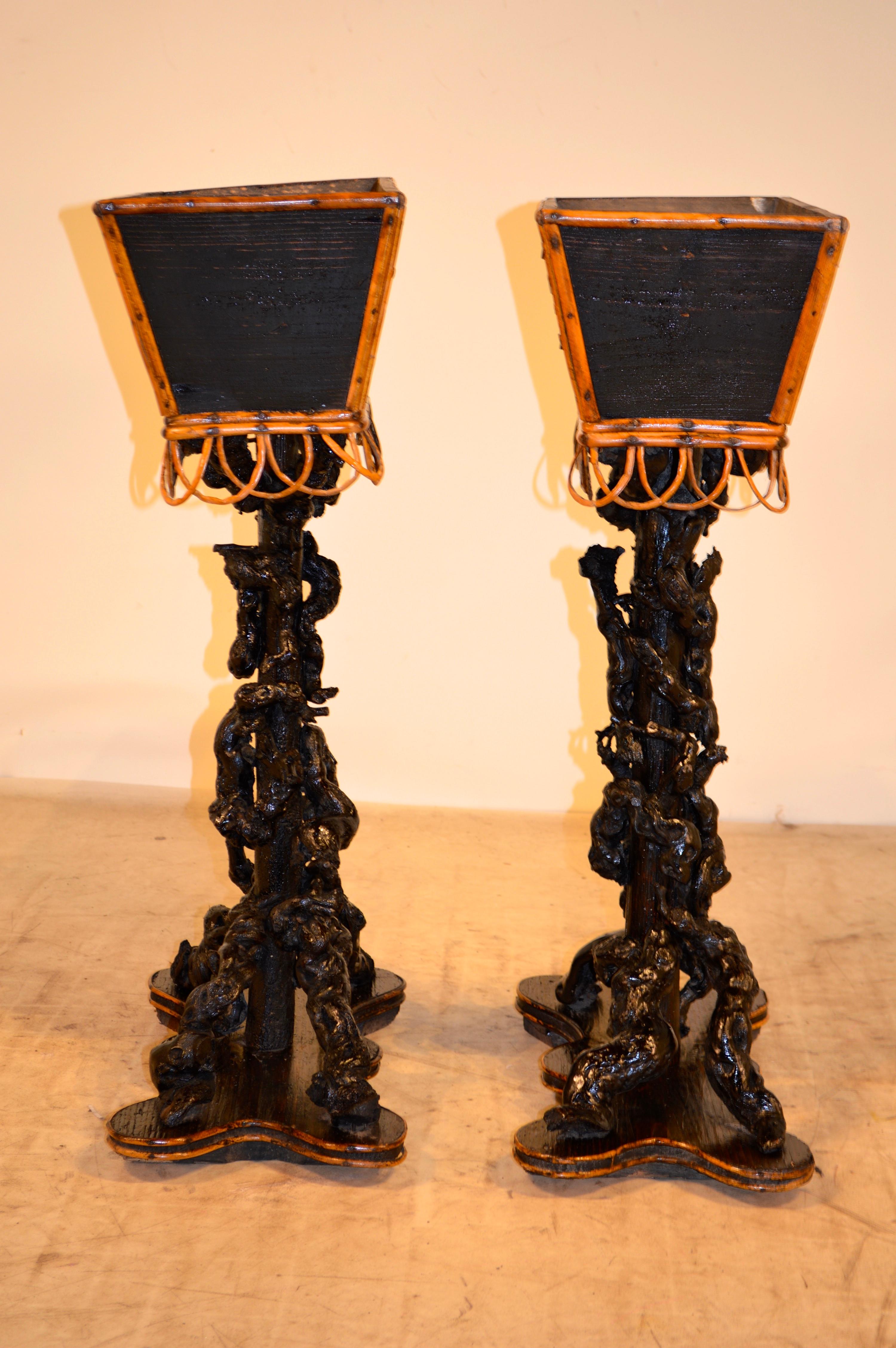 19th century pair of French twig planters from the Ardeche Mountain area of France. They have with pine planter boxes decorated with pinecones and twig ornamentation. The bases are made of pine with twisted twig design supports, resting on