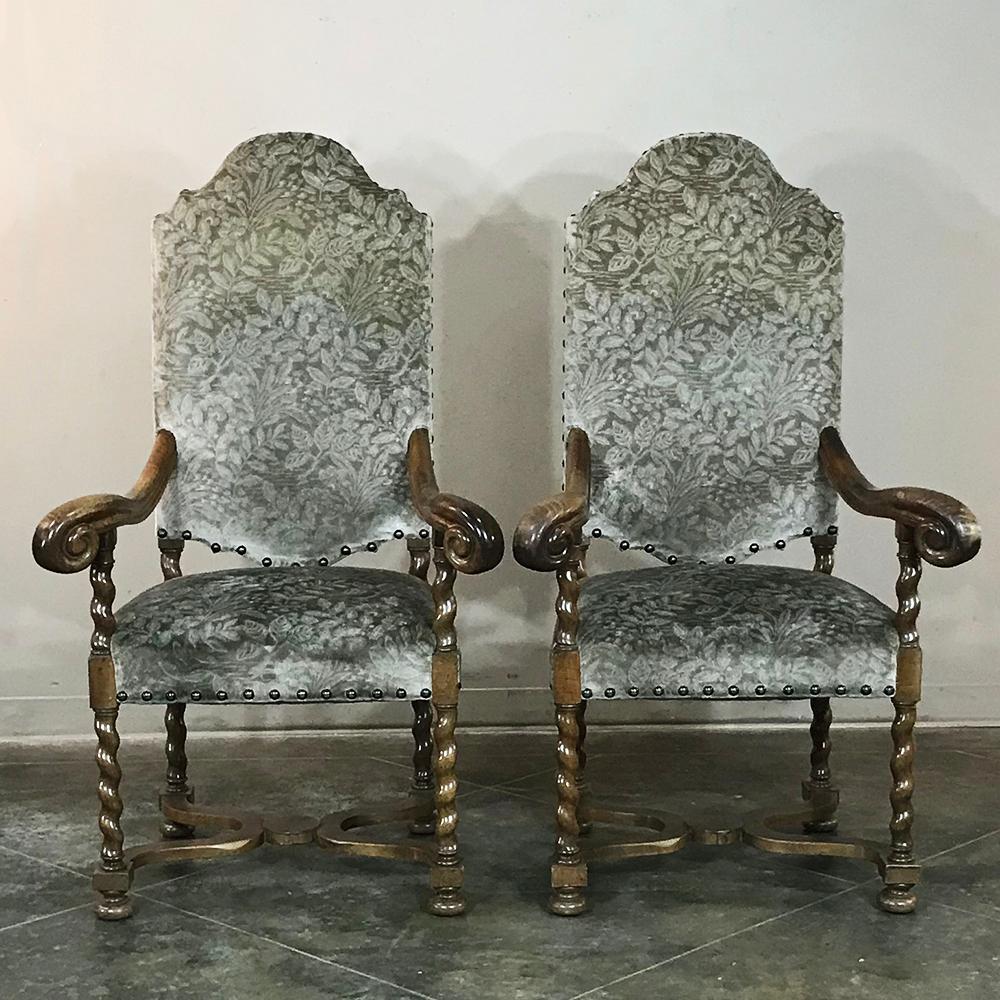 Pair of 19th century French antique Louis XIII barley twist armchairs were handcrafted from select maple wood, then carved to perfection with flowing, scrolled lines above, and tailored barley twist columns below. High, arched stately seat-back and