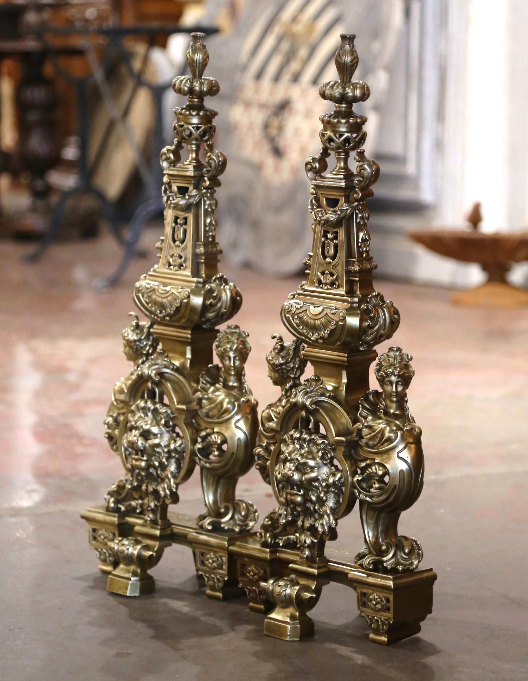 Decora il focolare di un camino con questa intricata coppia di Chenet antichi. Realizzato in Francia intorno al 1860 e costruito in bronzo, ogni ferro da stiro ornato presenta pesanti dettagli, tra cui una testa di leone prominente circondata da