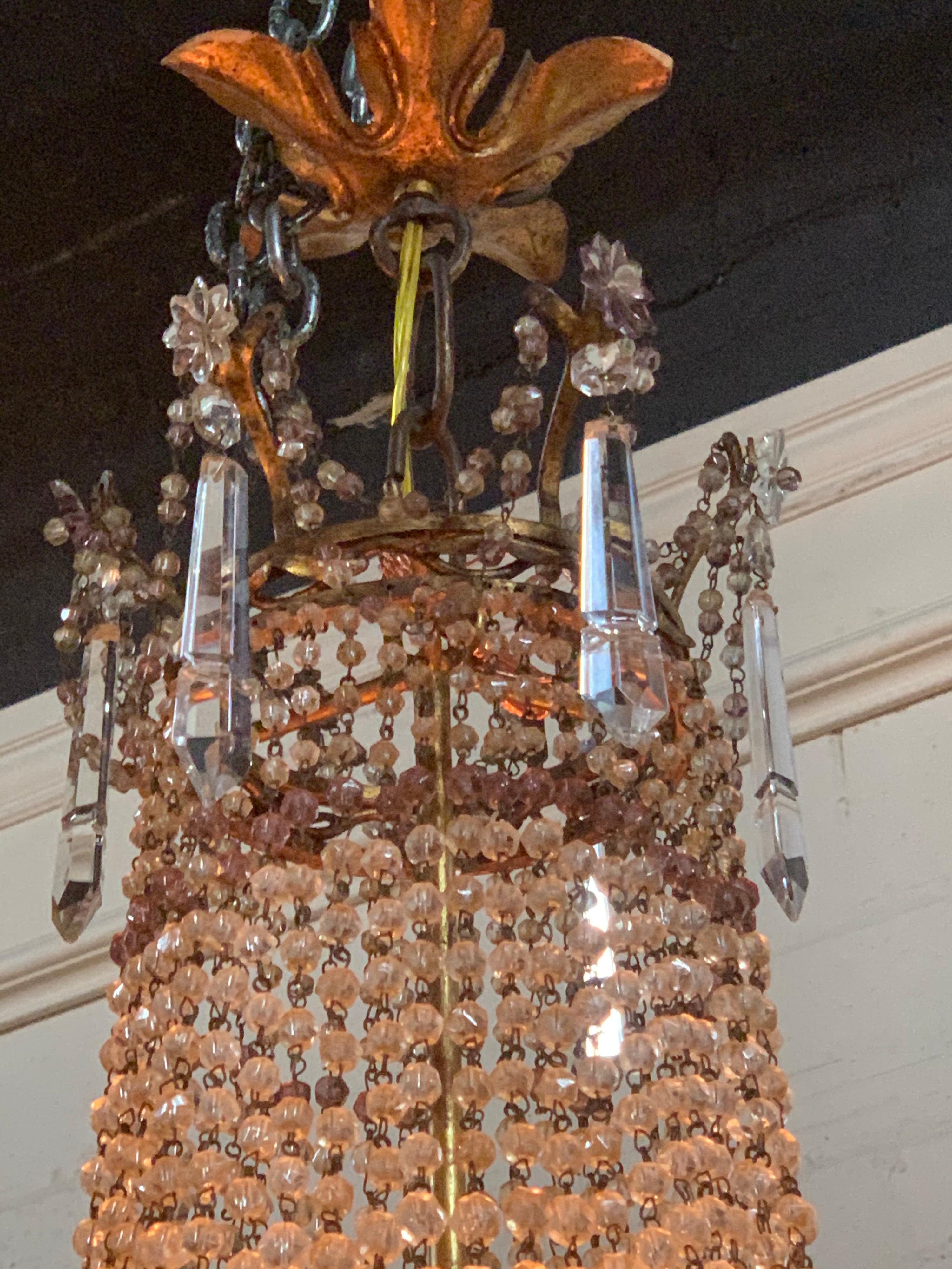 Fabulous pair of 19th century French beaded crystal and amethyst basket form chandeliers. Very fine quality. These glistening beauties are sure to impress! Exquisite!