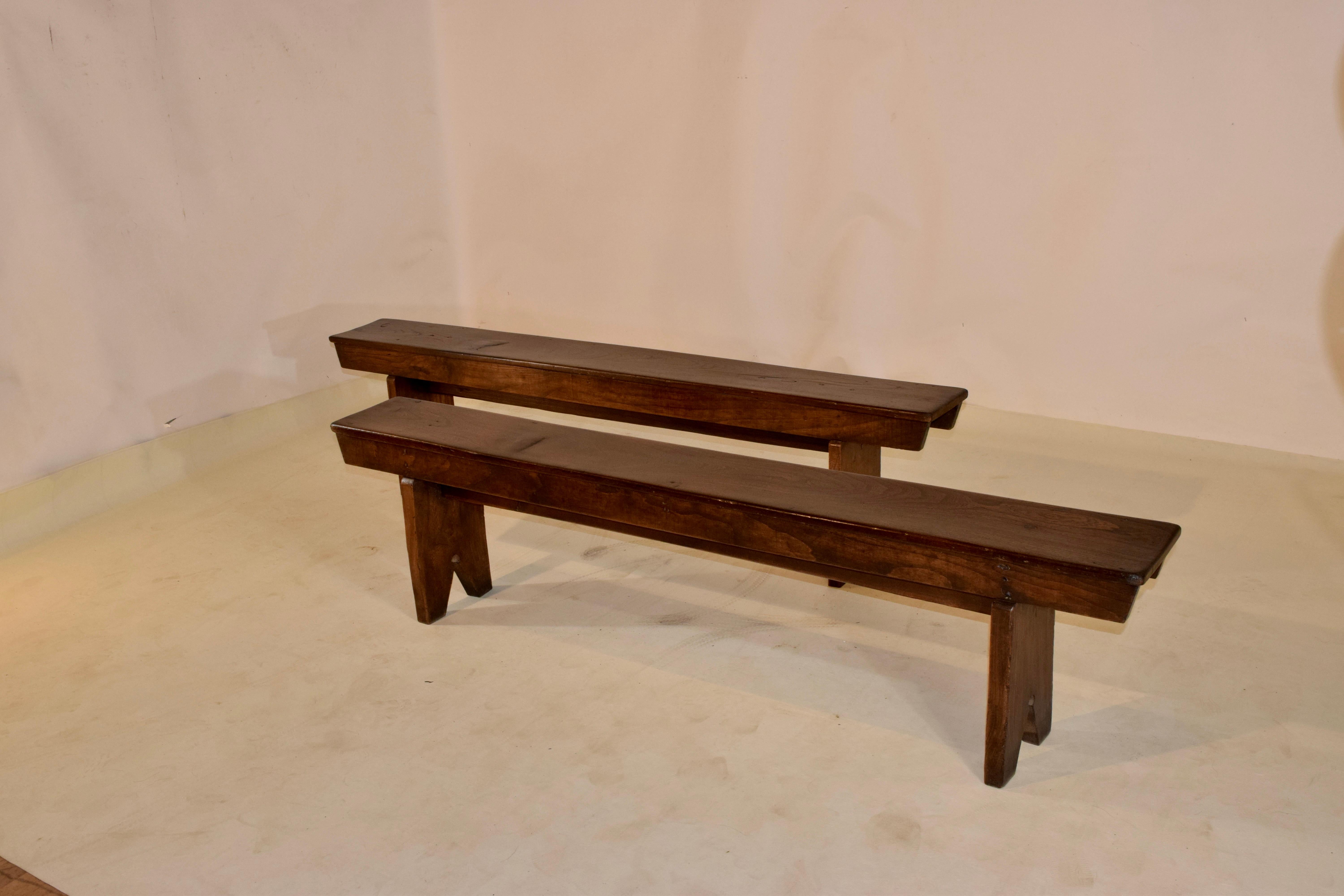 Pair of 19th century elm benches from France with simple and elegant lines to complement any style of decor. The wood is wonderfully grained throughout the benches and they are of a very simple design. The patina is a rich brown color which you only