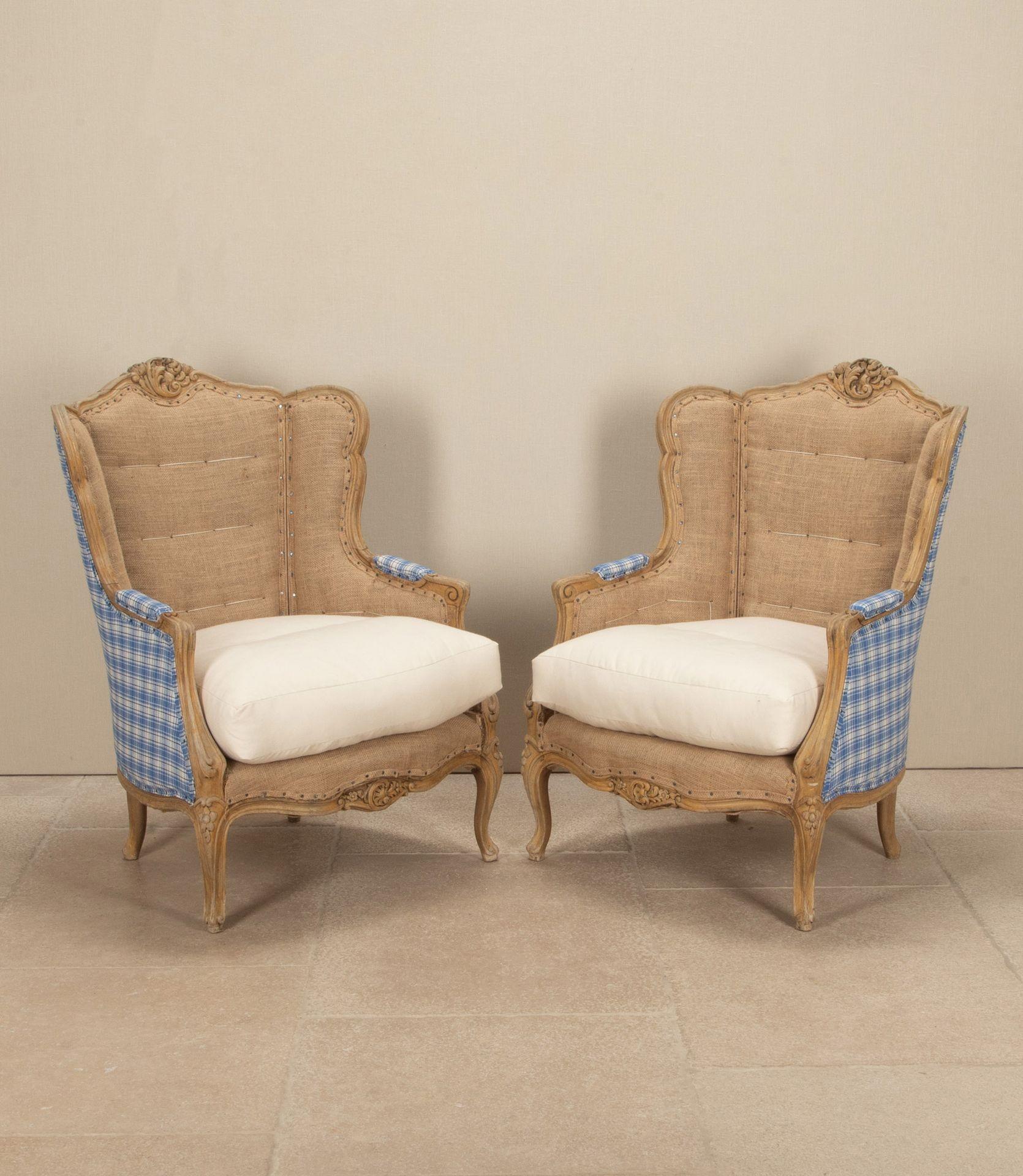 A gorgeous pair of large 19th Century French 'bergeres' or armchairs. Carved wooden frames and upholstered in the stylish 'deconstructed' manner. With the backs and armrests covered with old French blue and white checked fabric. While the fronts