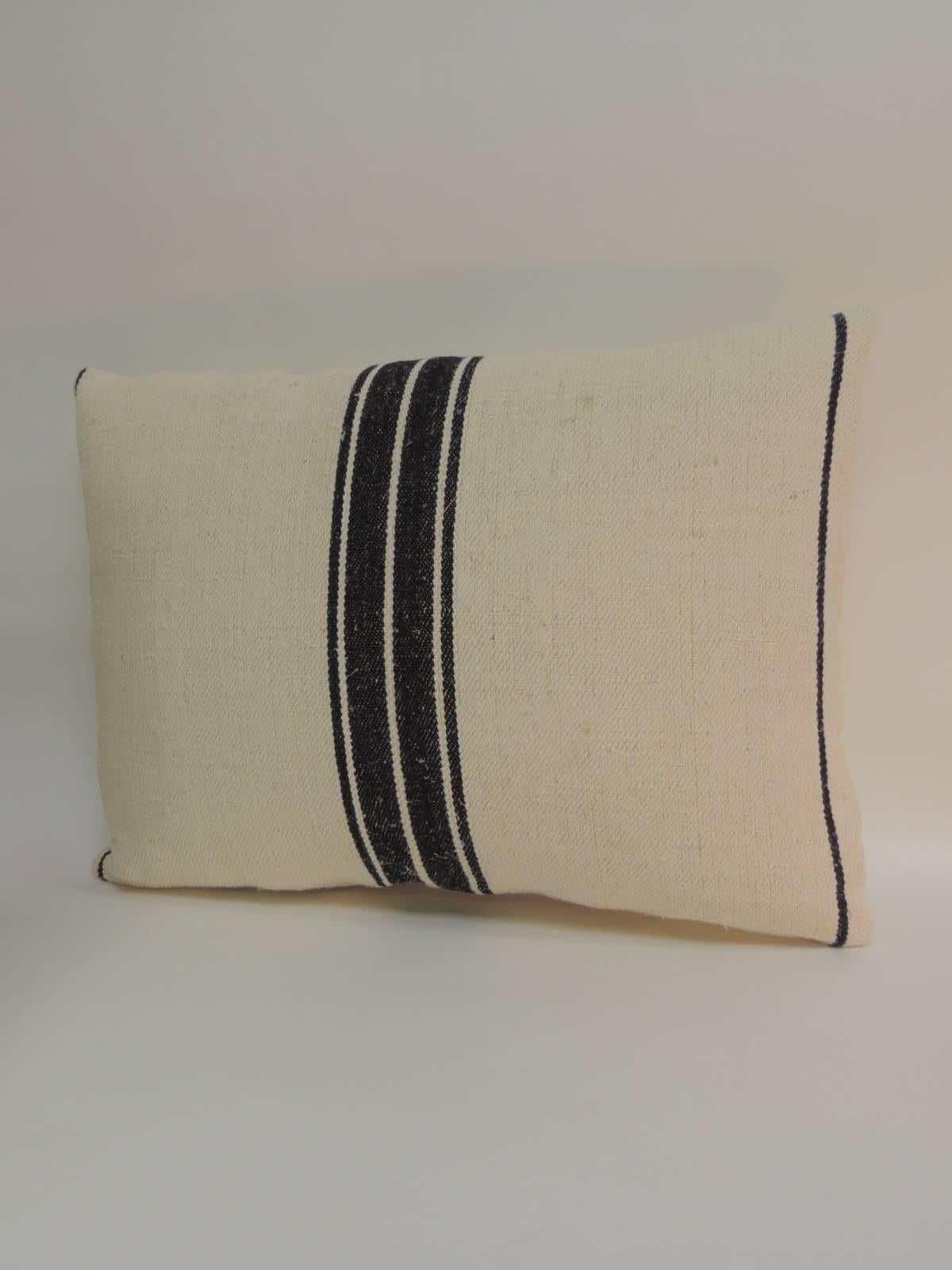 Pair of 19th century French stripes lumbar decorative pillows in natural and black. Decorative pillows textile show vertical stripes on tan with a woven homespun textile. French decorative cushions finalized with natural linen backings. Throw