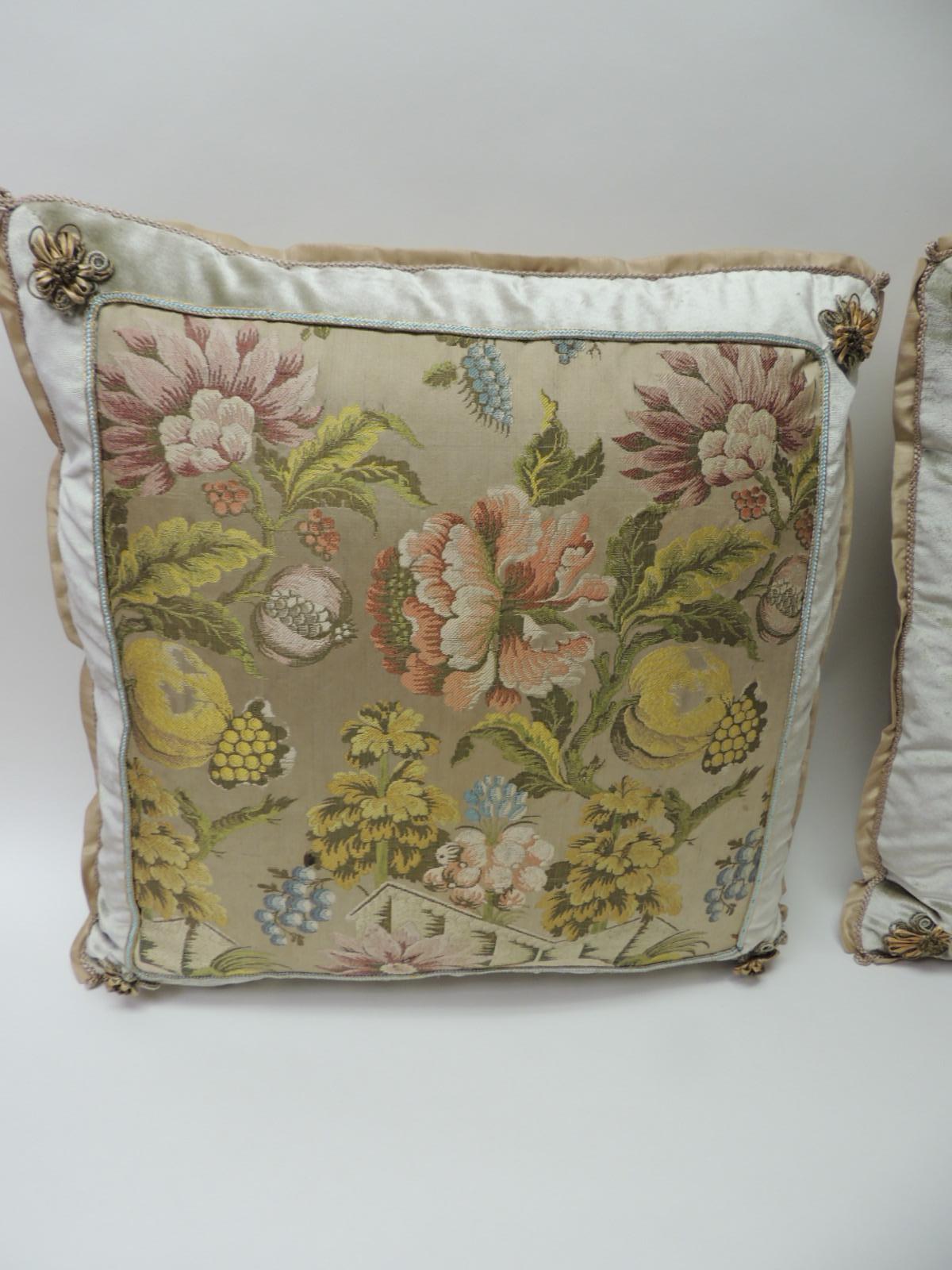 Pair of 19th century French brocade floral decorative pillows
Pair of yellow and green floral square antique textile decorative pillows. Colorful French woven silk brocade pillows, framed with silk velvet and embellished with a small silk blue and