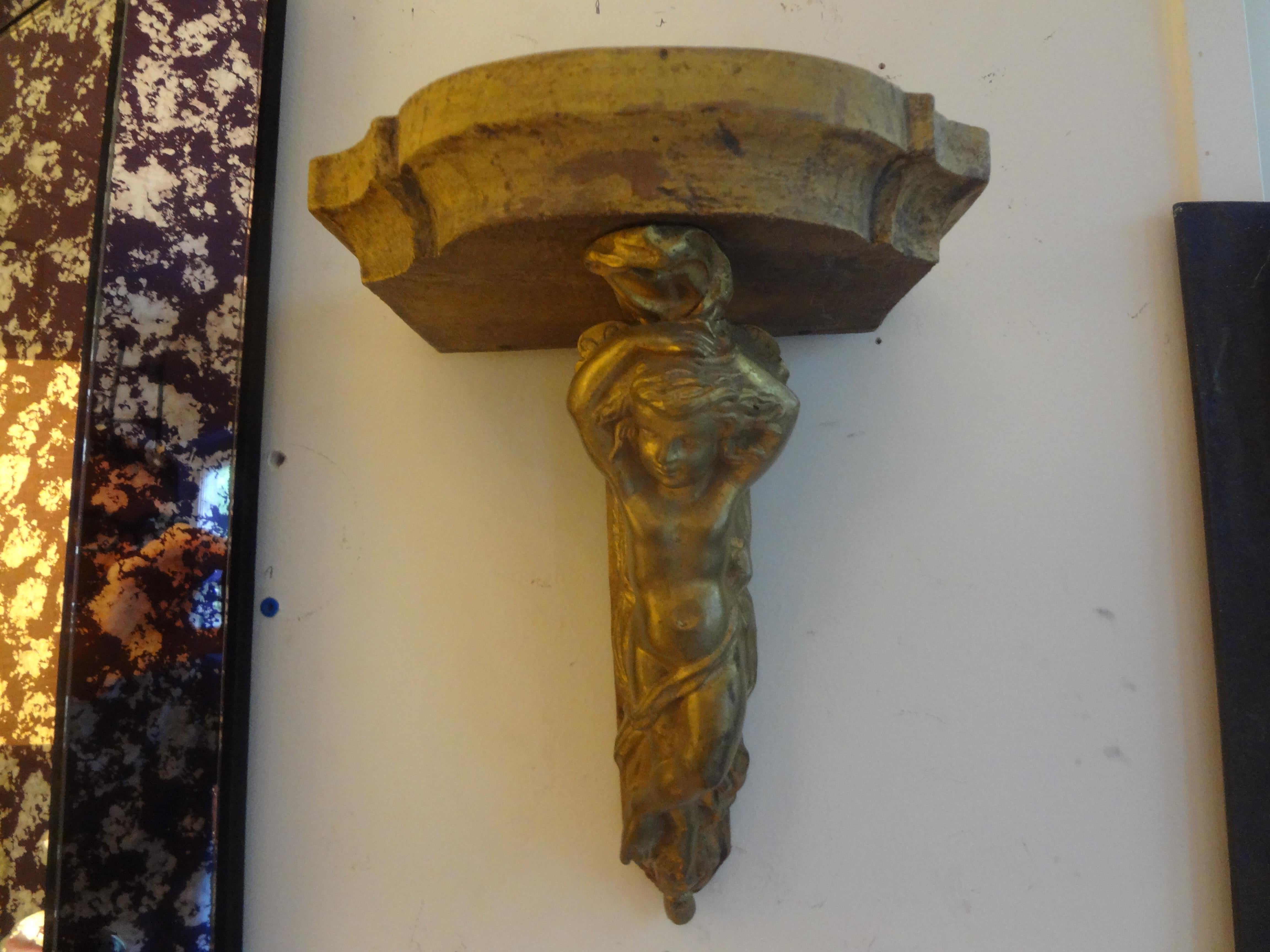 Interesting pair of antique French Napoleon III gilt bronze and wood wall shelves or consoles with cherub supports and wood tops. These stunning antique French wall brackets have a good top surface area to accommodate your favorite prized