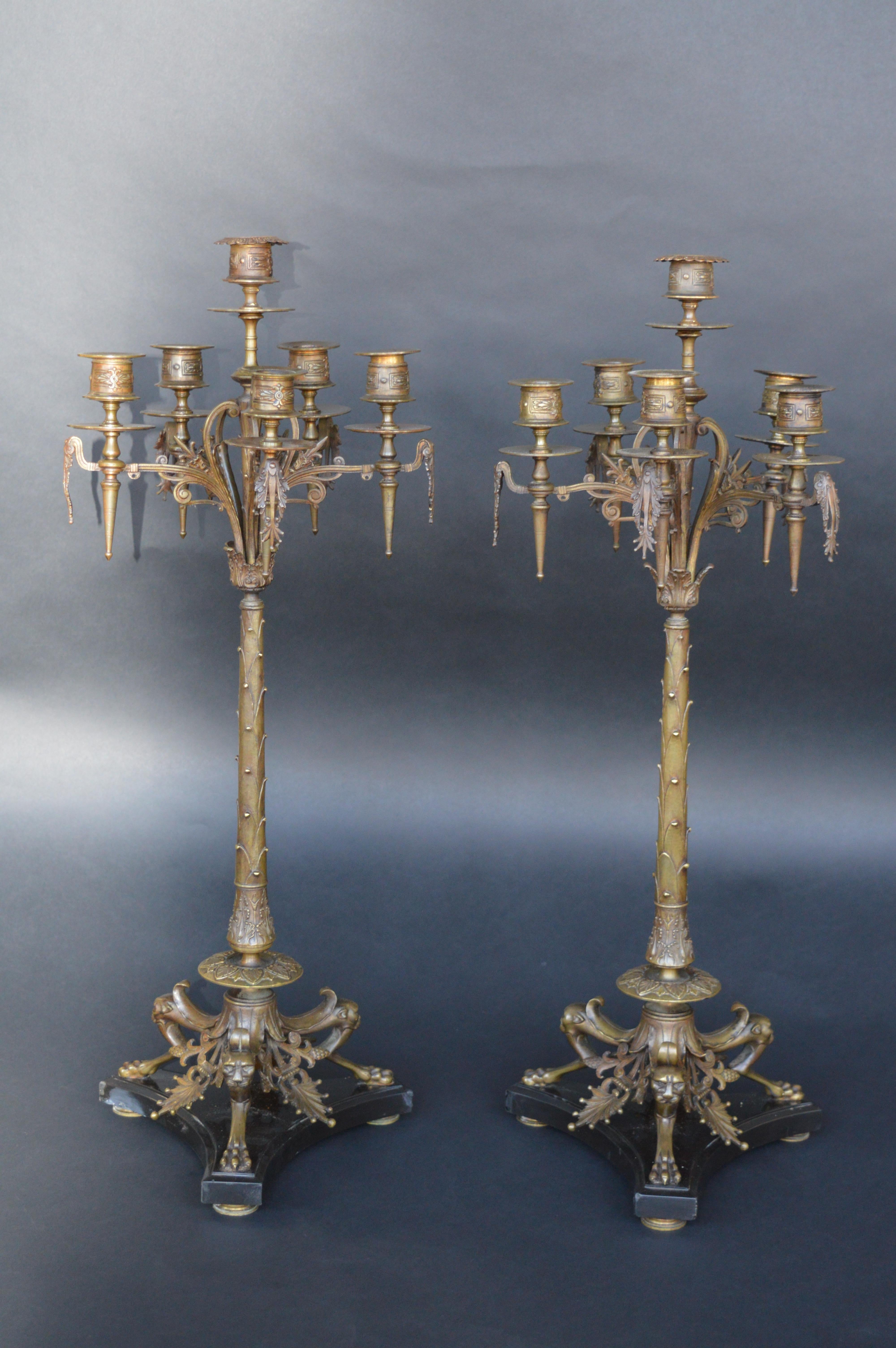 Pair of 19th Century French Bronze Candelabras with claw feet on black marble base.