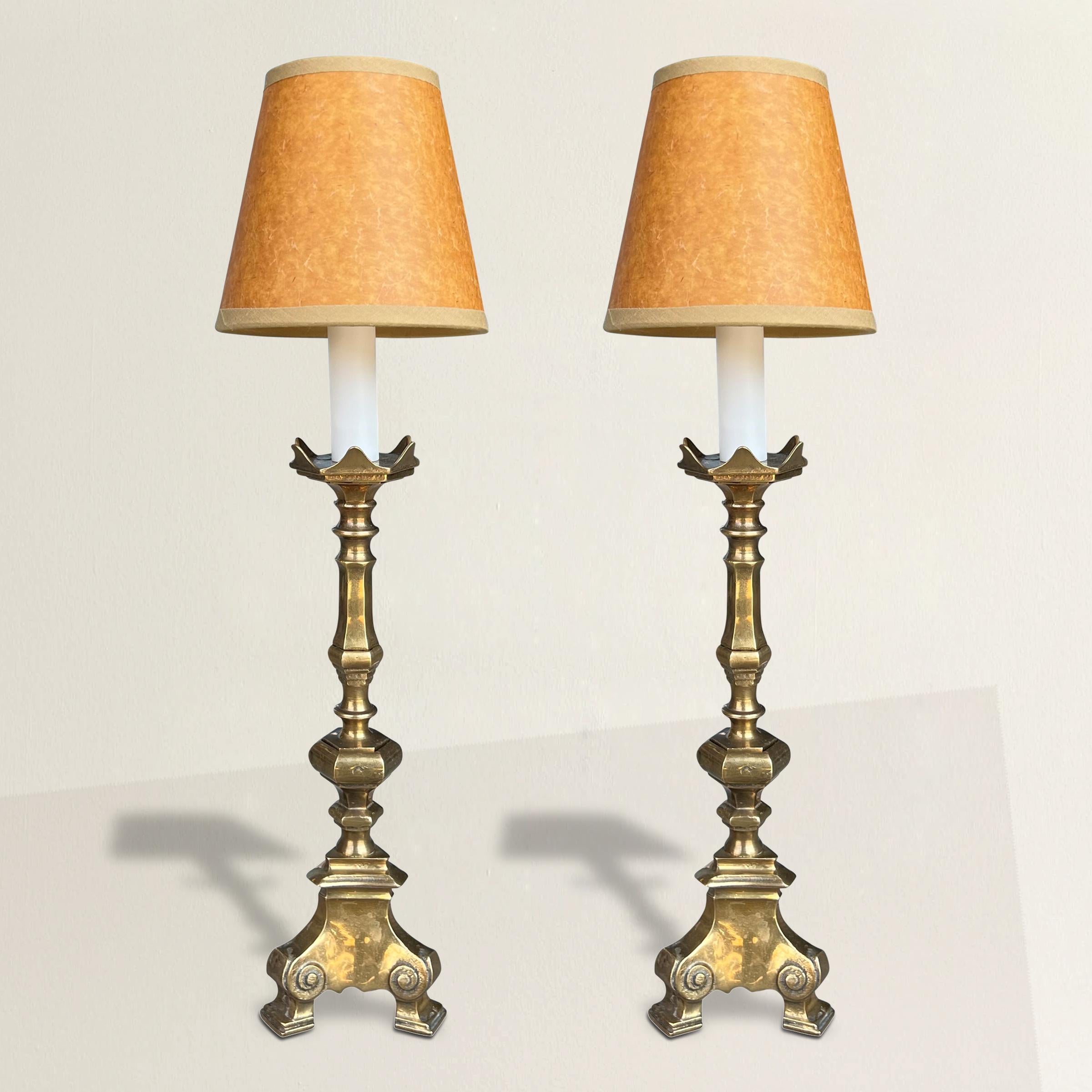Step into the allure of the past with this pair of 19th-century French bronze candlesticks, thoughtfully transformed into radiant lamps. Electrified with precision, their once-candlelit elegance now casts a soft glow through delicate paper shades.