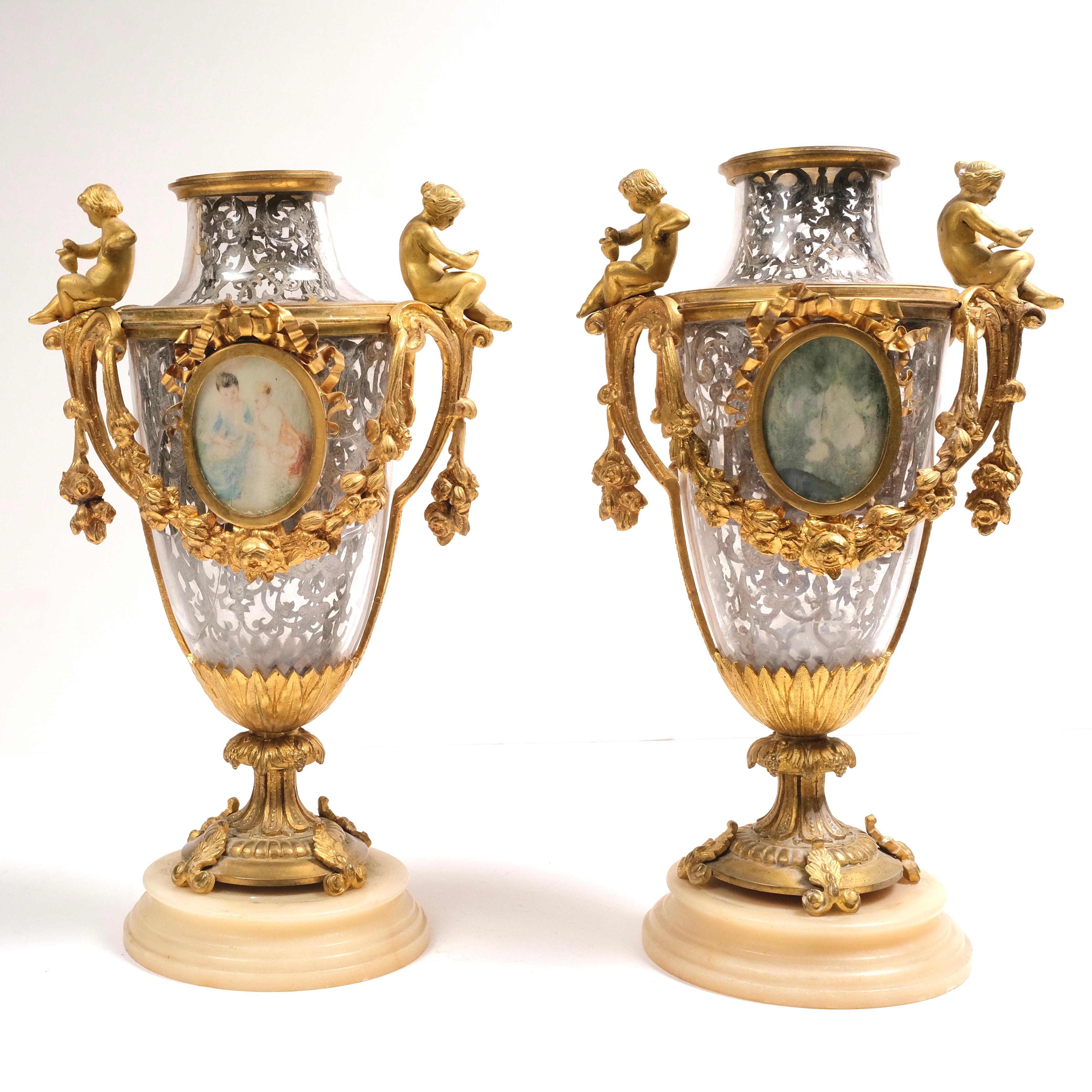 Dore bronze with silver filigree on the inside of the glass vase. One glass is cracked/broken, but is difficult to see. Marble bases.