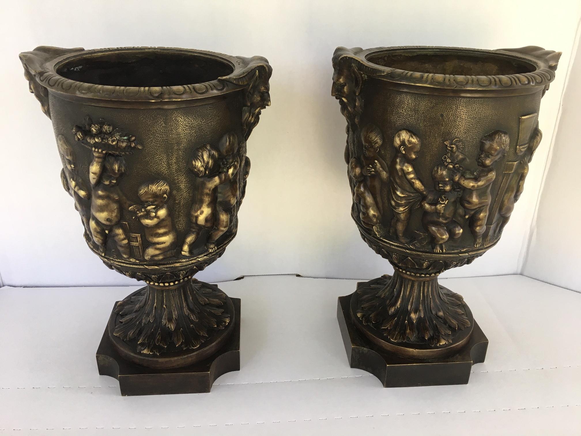 Pair of 19th century French bronze urns after Clodion

Superb pair of French classical bronze open urns. These heavy urns are patinated and casted in exceptional quality. The body is adorned with frolicking putti with stylized satyr handles. The