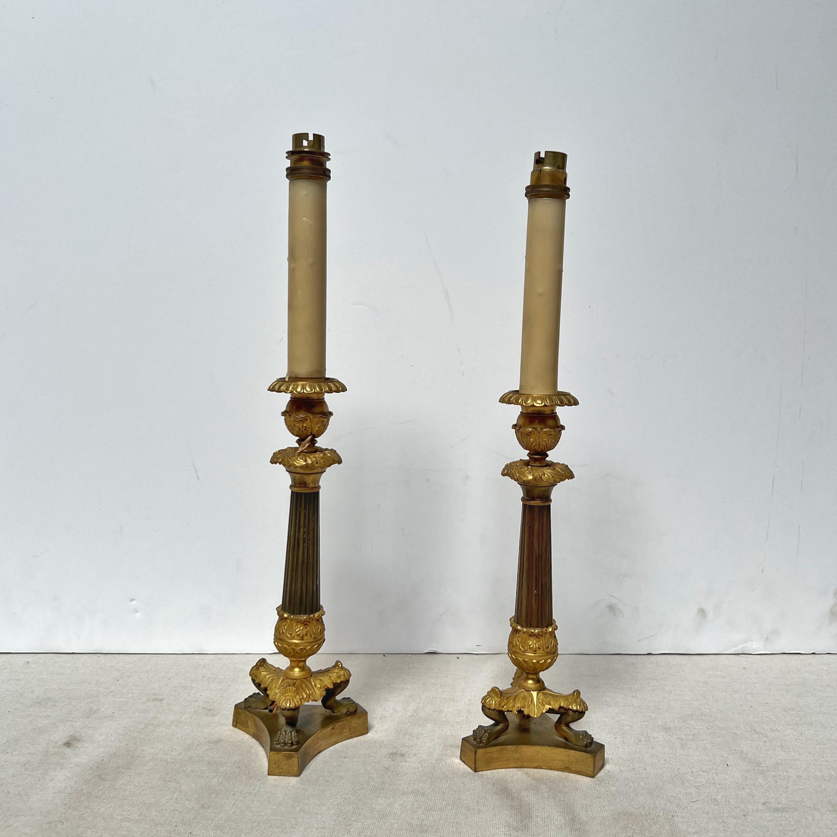 Coppia di candelabri francesi Restauration di alta qualità in ormolu e bronzo patinato.  Questi candelieri in stile Impero sono stati precedentemente forati per l'elettricità, ma possono essere ricablati o utilizzati con le candele.  Sono alti 11