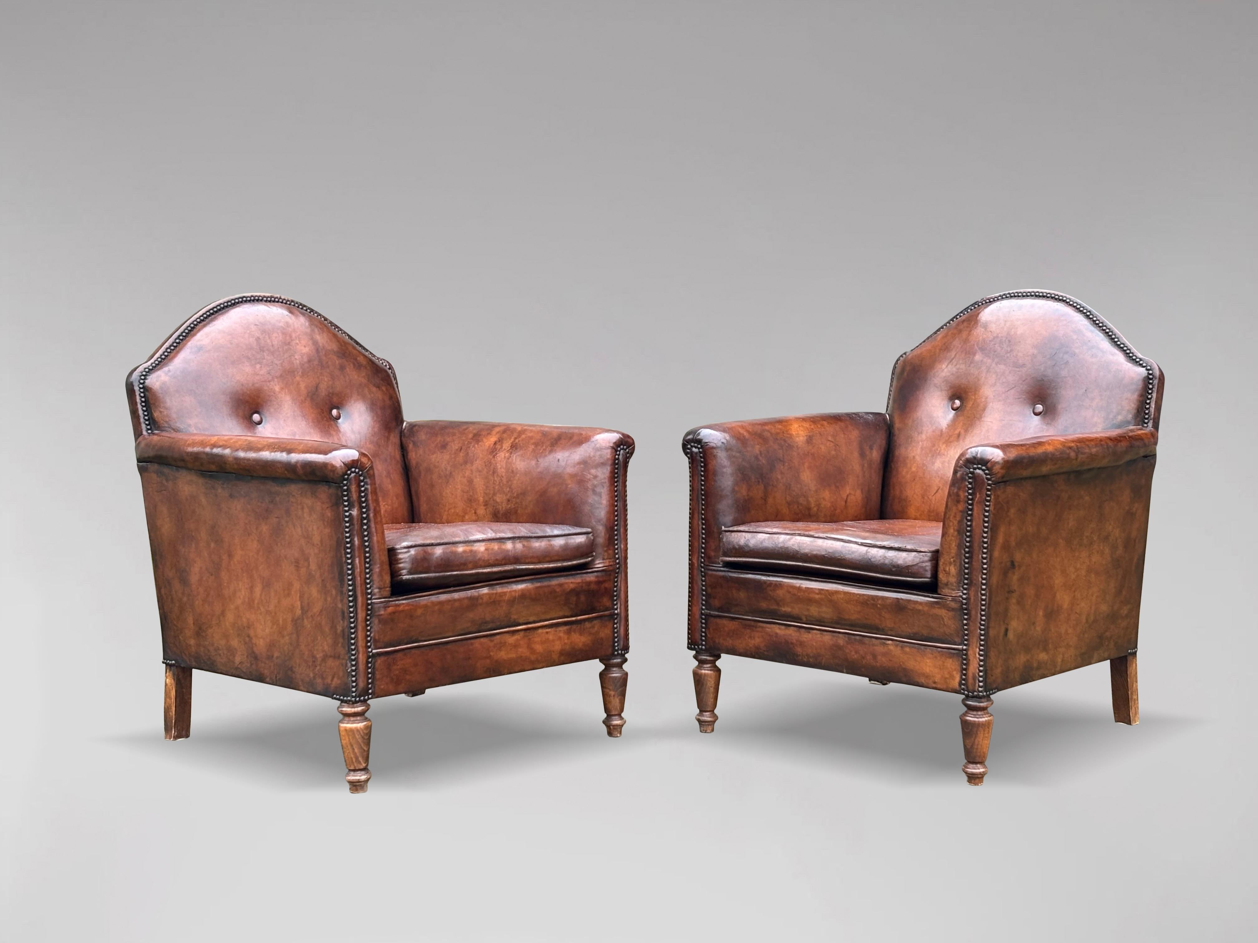 A fine pair of stunning quality 19th century French brown leather library armchairs, standing on turned oak legs. Very comfortable with great colour to the leather. Retaining the original leather and studs, shaped back, loose feathered cushion,