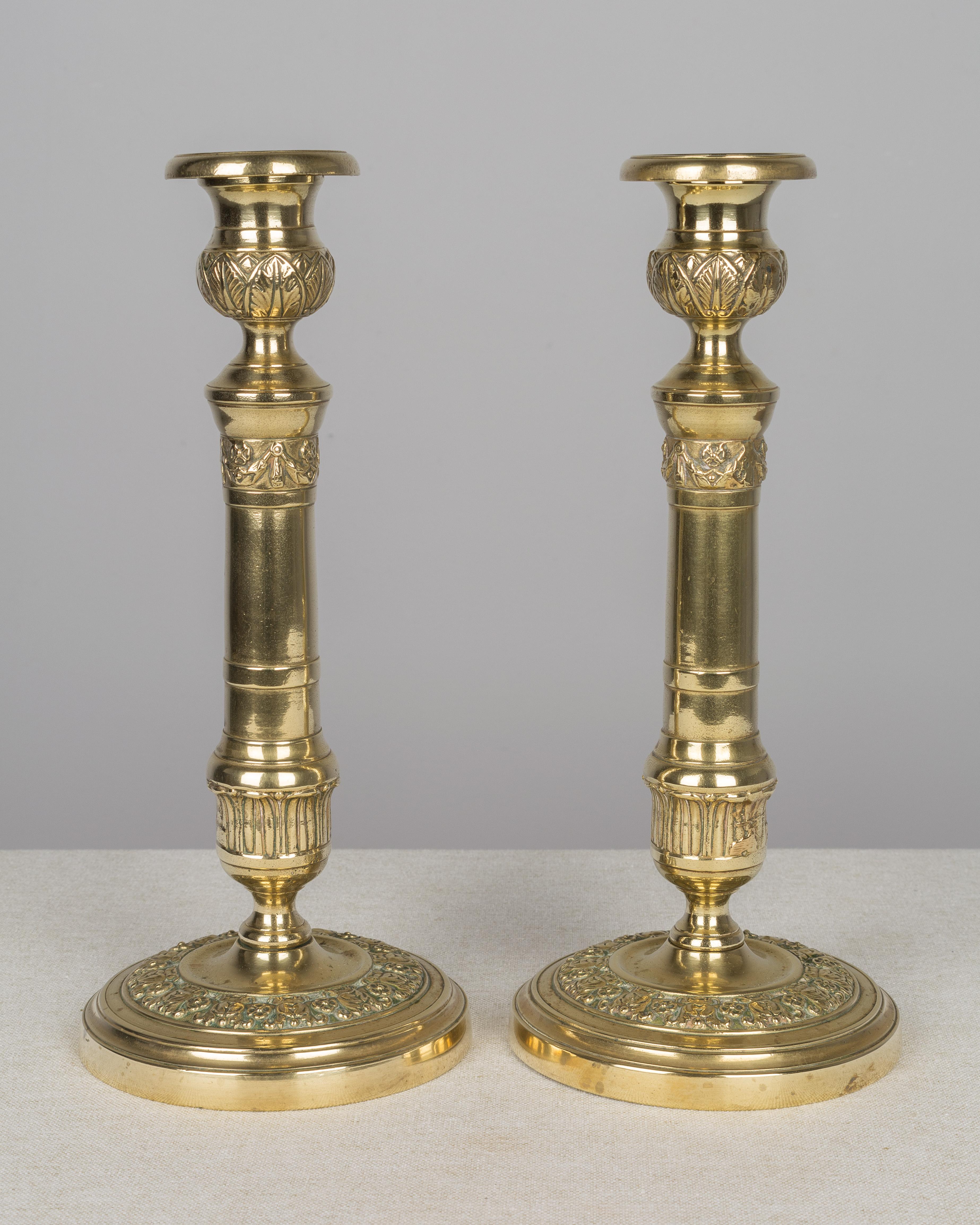 Pair of 19th century French Louis XVI style polished brass candlesticks.
