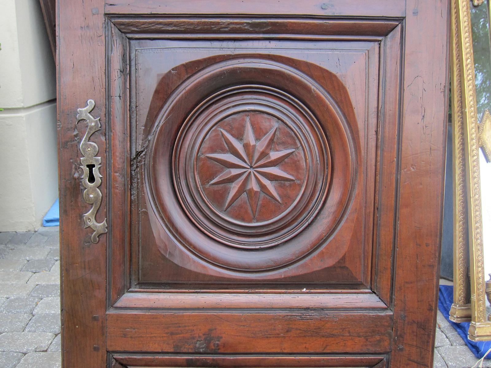 Pair of 19th century French carved armoire doors with star.
