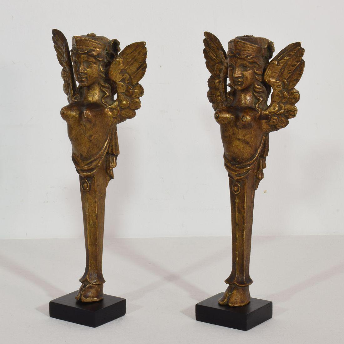 Nice couple of two giltwood neoclassical ornaments,
France, circa 1800-1850. Weathered, small losses and old repairs. Measurement here below includes the wooden base.