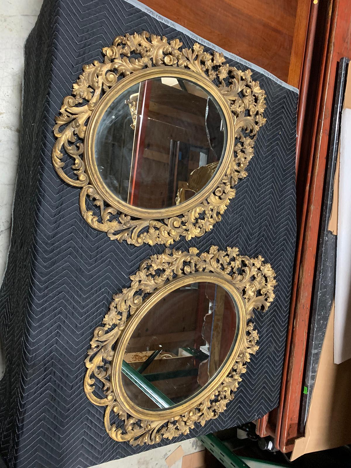 Pair of 19th century English carved giltwood oval mirrors.